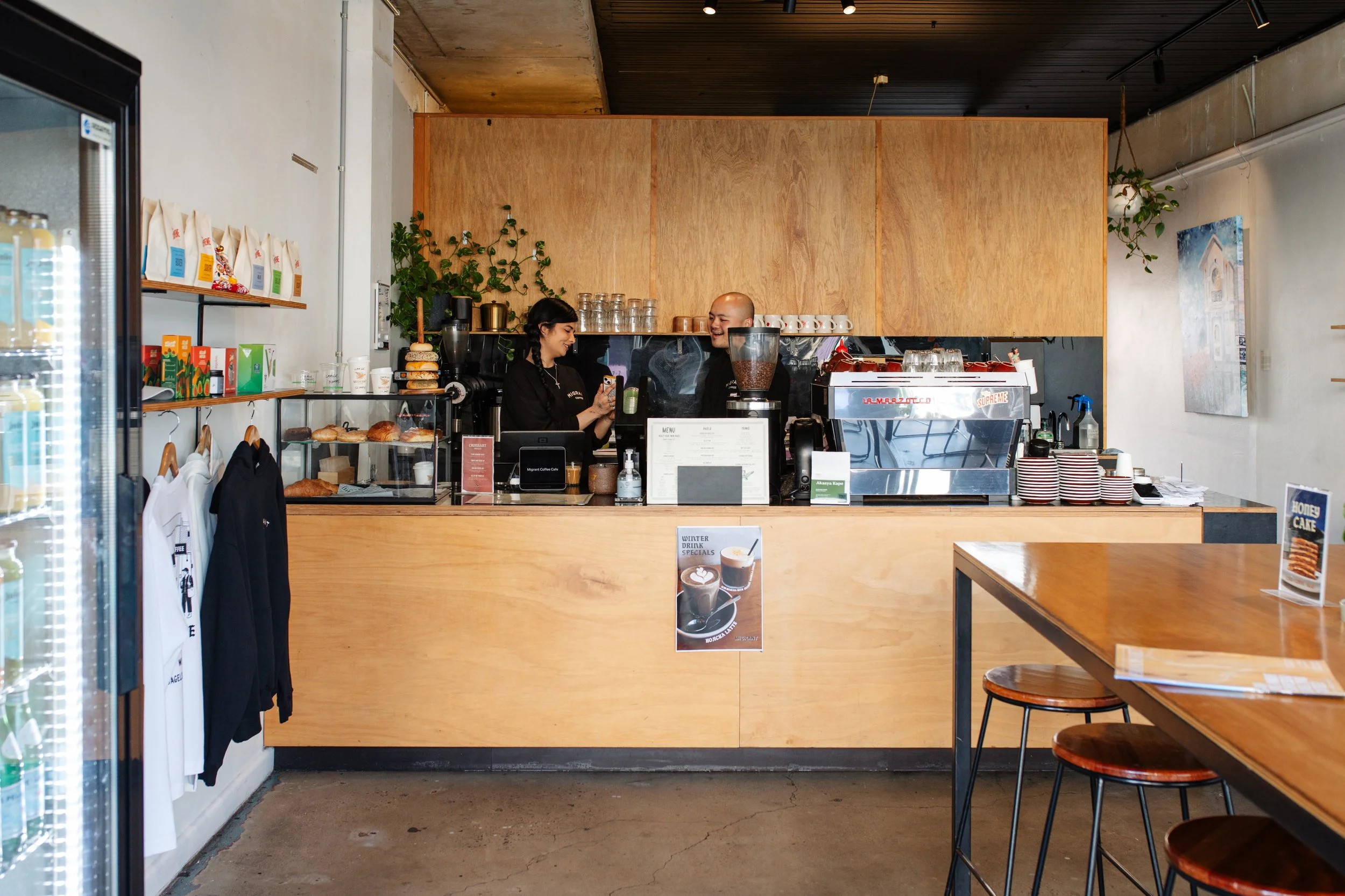 Indoor bar counter at Migrant Coffee with friendly staff