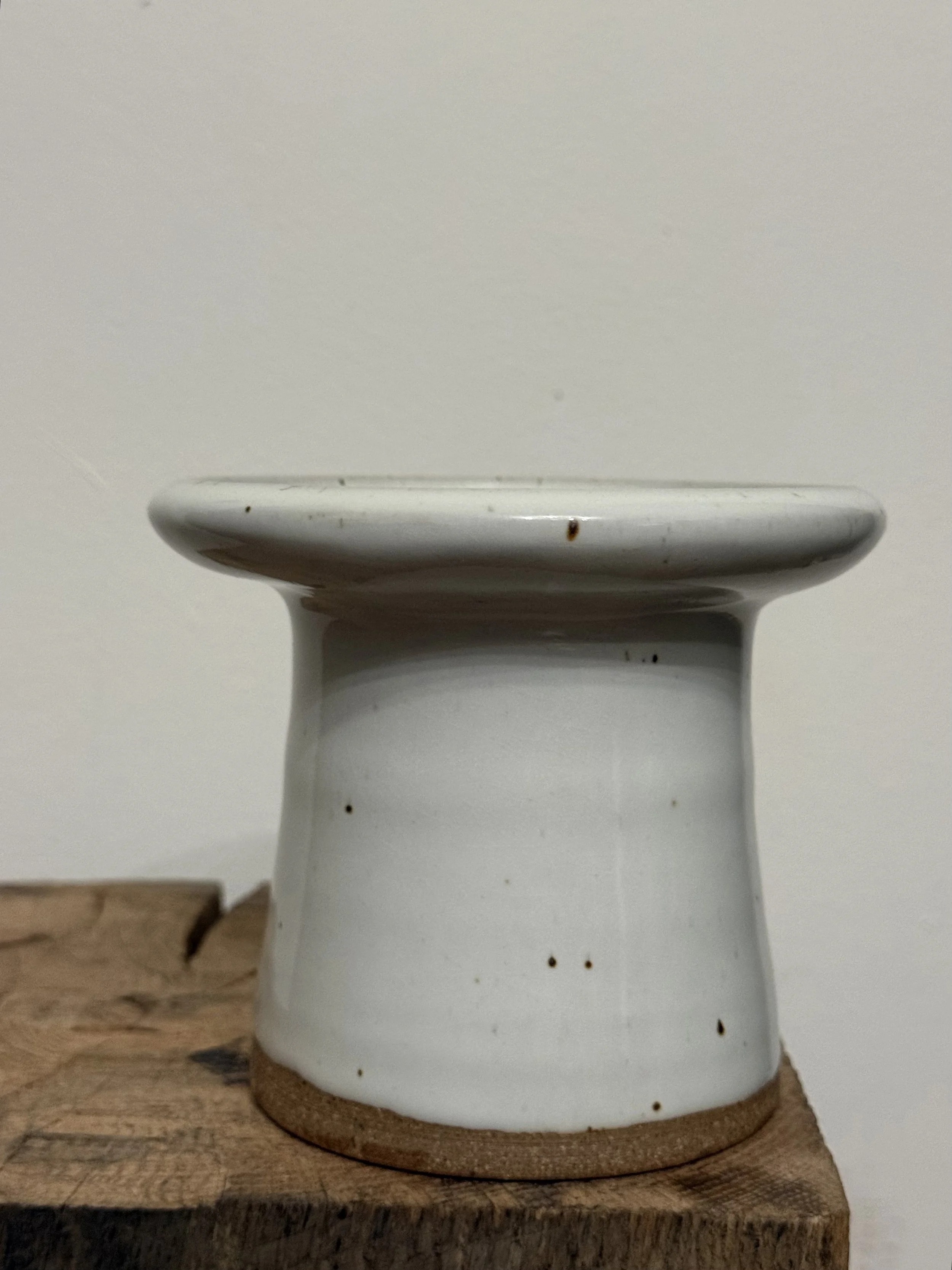 white pedestal vessel