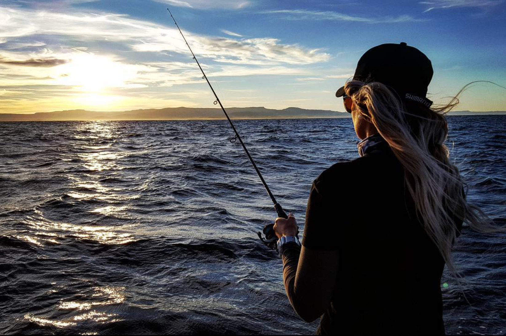 An angler fishing offshore at sunset during the Stradic CI4+ shoot.