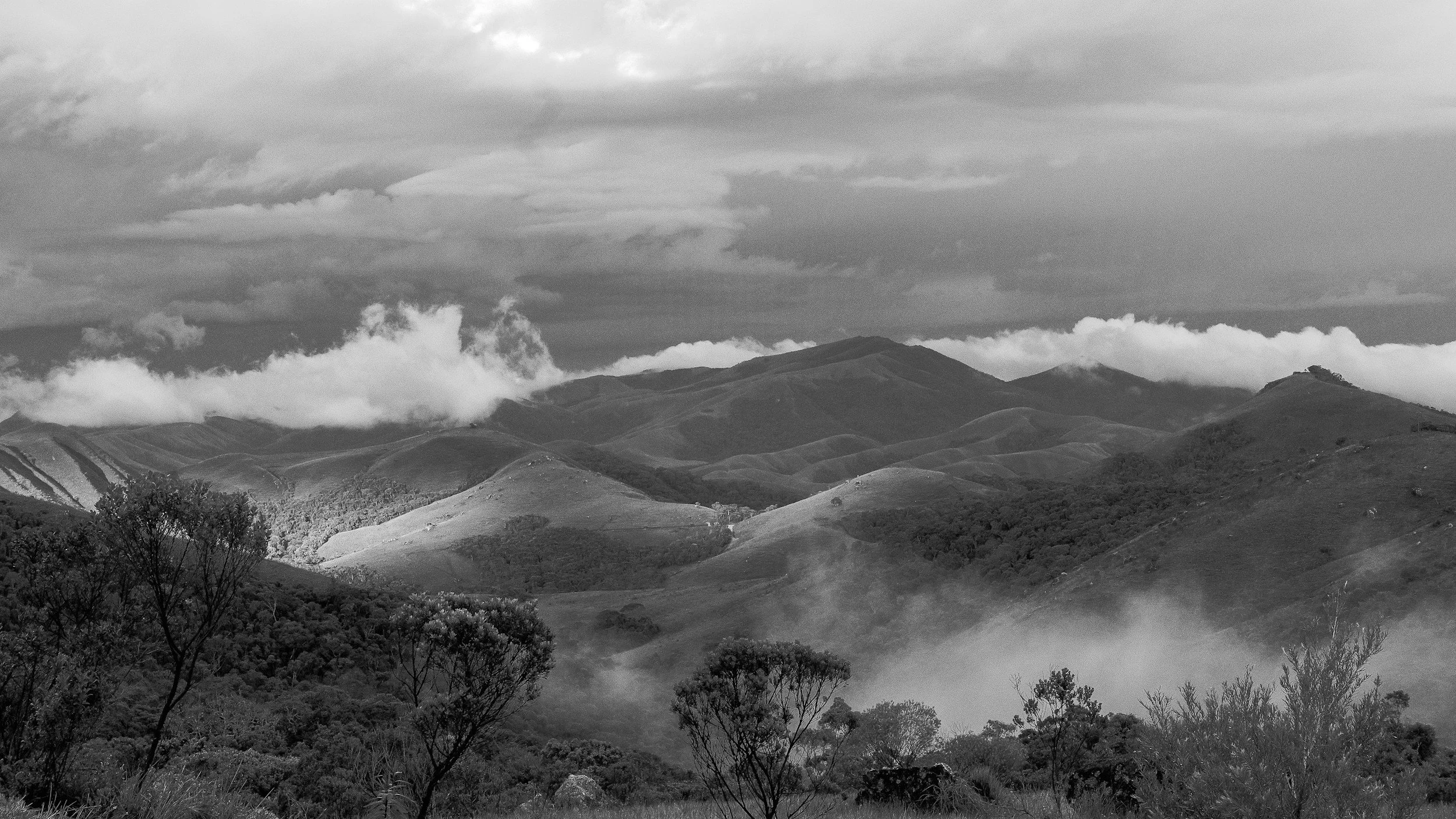 Black and white landscape photo of rolling Santa Fe mountains