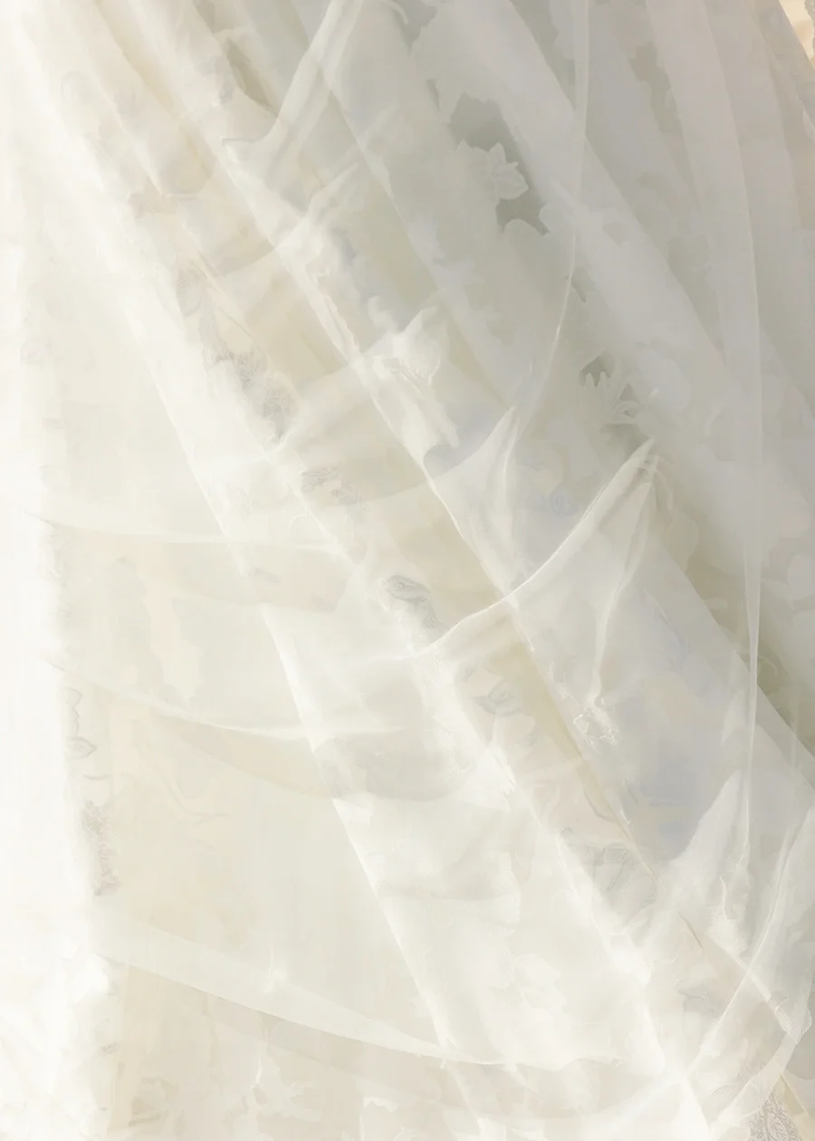 Close-up of clear plastic or cellophane material with folds and reflections.