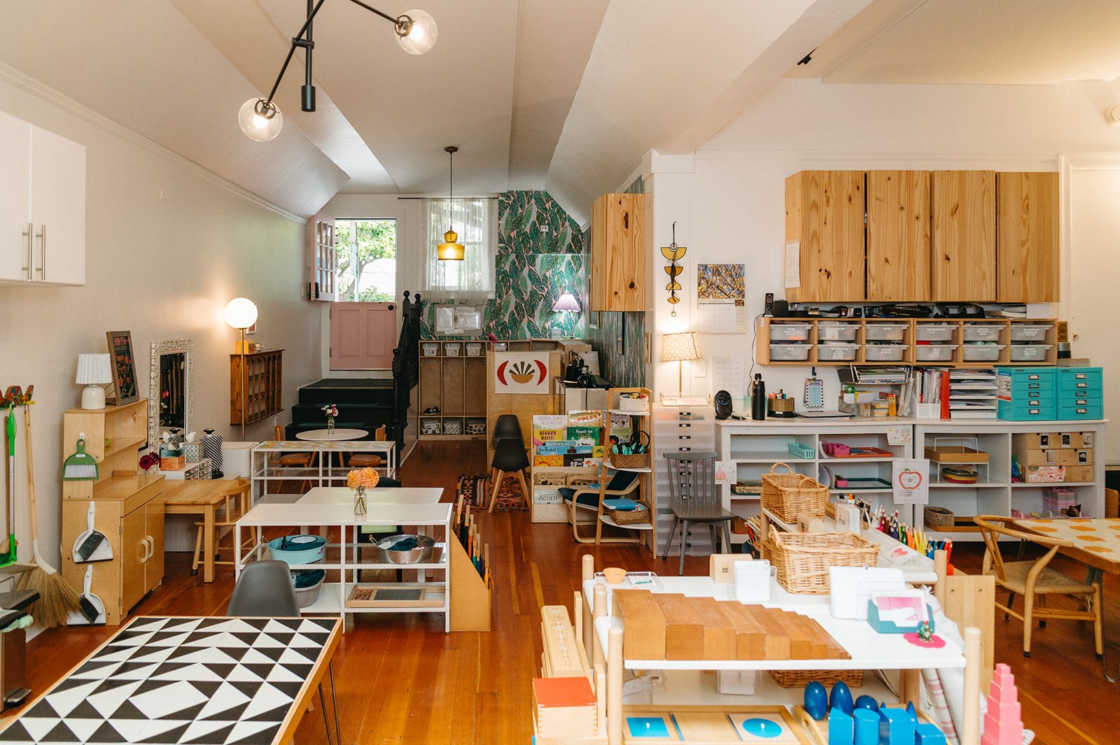 Little Eden Montessori preschool classroom, with low open shelves, natural light, and a tiled work table