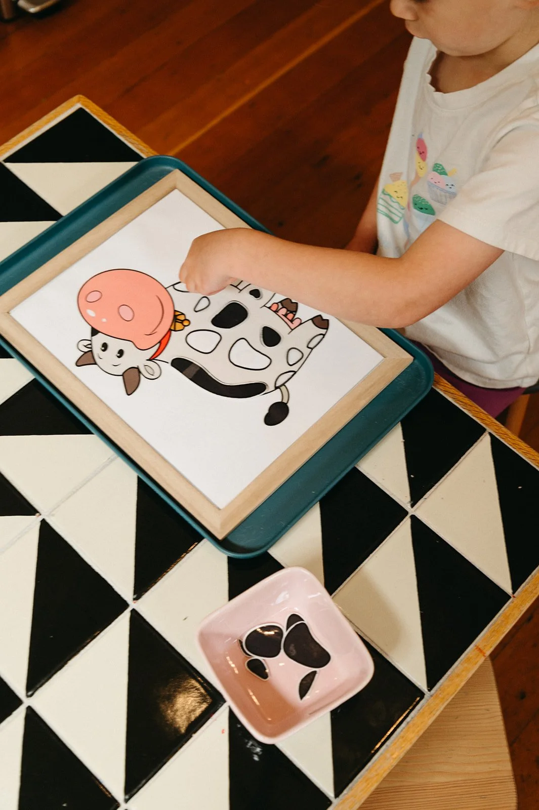 Child playing on a tablet during creative art time