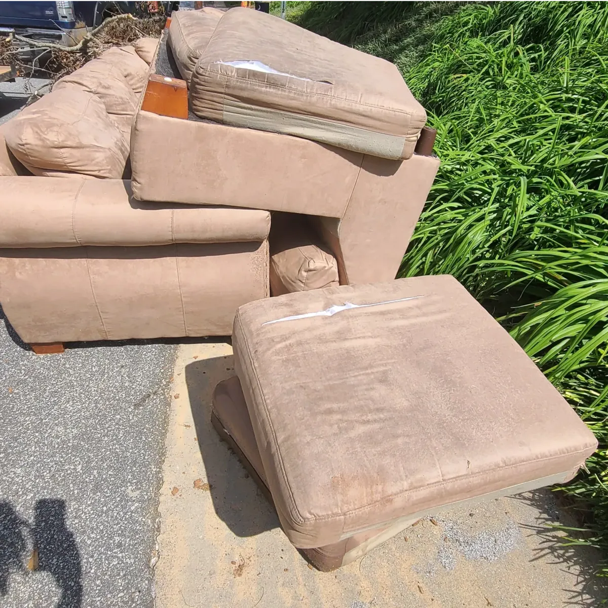 Upholstered furniture — a sofa, armchair, and ottoman — set outdoors for furniture removal in Memphis, TN.