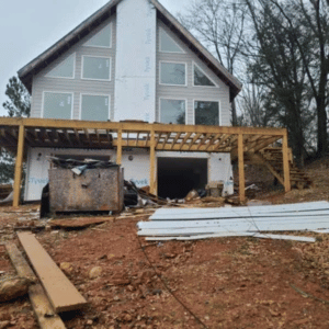 Home under construction with deck framework and building materials during a construction debris removal job in Memphis, TN.