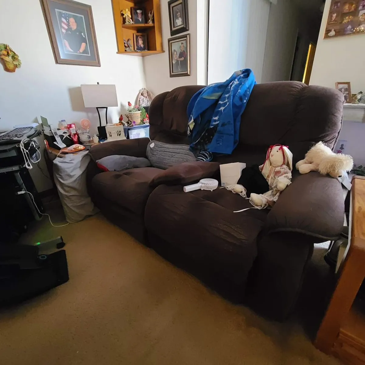 Cluttered living room with furniture and belongings before a specialized hoarding cleanout in Memphis, TN.