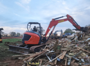 Excavator clearing debris during a demolition job in Memphis, TN.