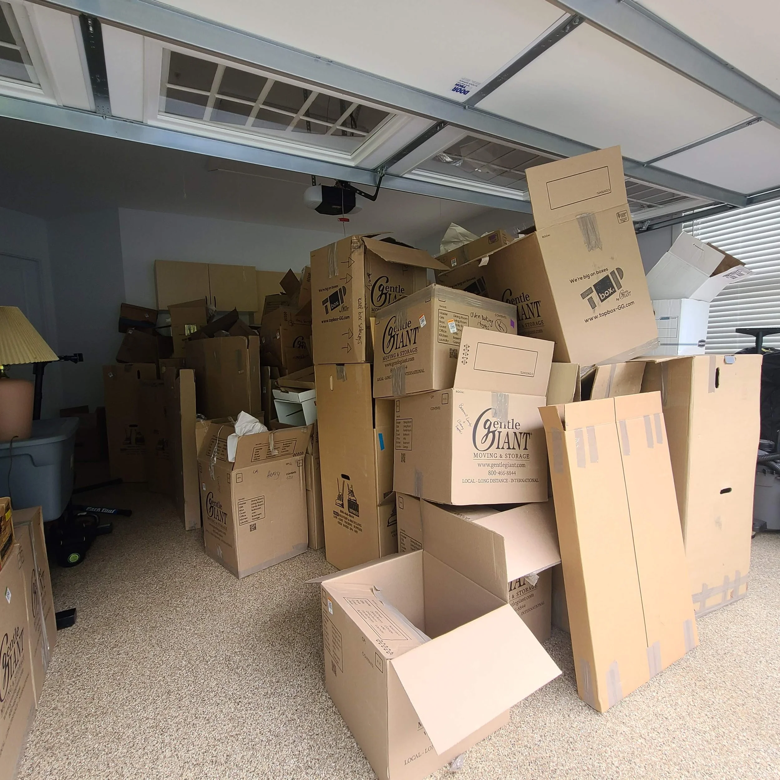 Garage packed with moving boxes before a residential junk removal cleanout in Memphis, TN.