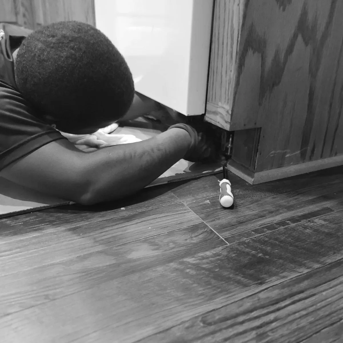 Removing a kitchen cabinet panel during an appliance and fixture removal job in Memphis, TN.