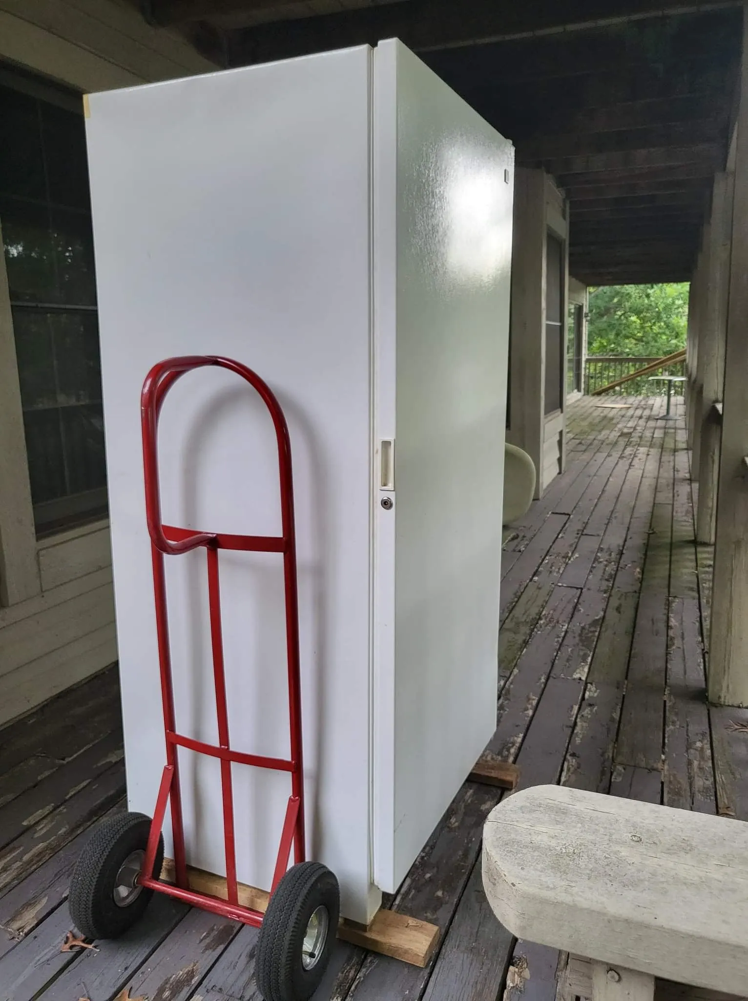 Refrigerator being moved on a hand truck during an appliance removal job in Memphis, TN.