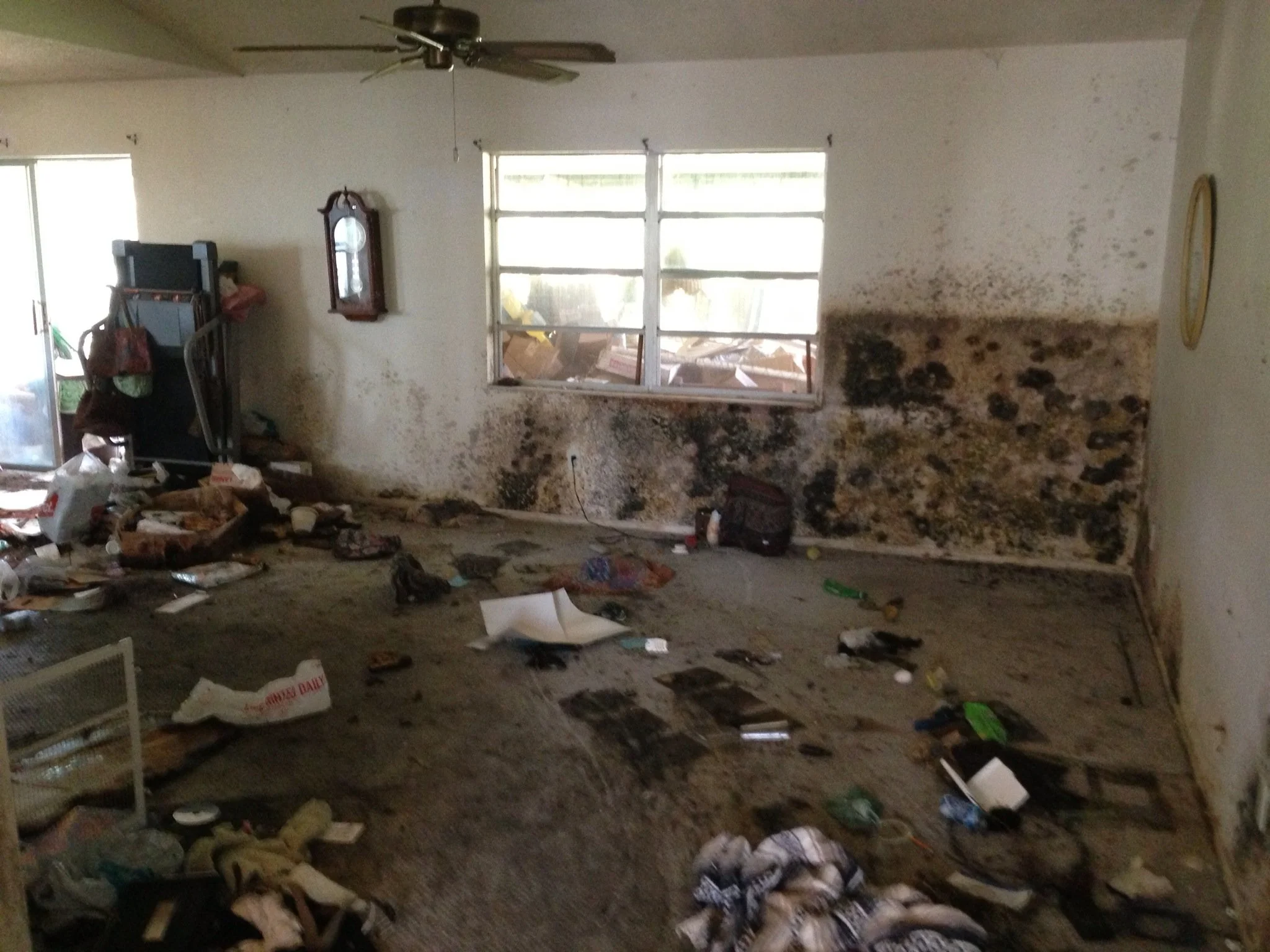 Room with fire and mold damage cluttered with debris before a specialized cleanout in Memphis, TN.