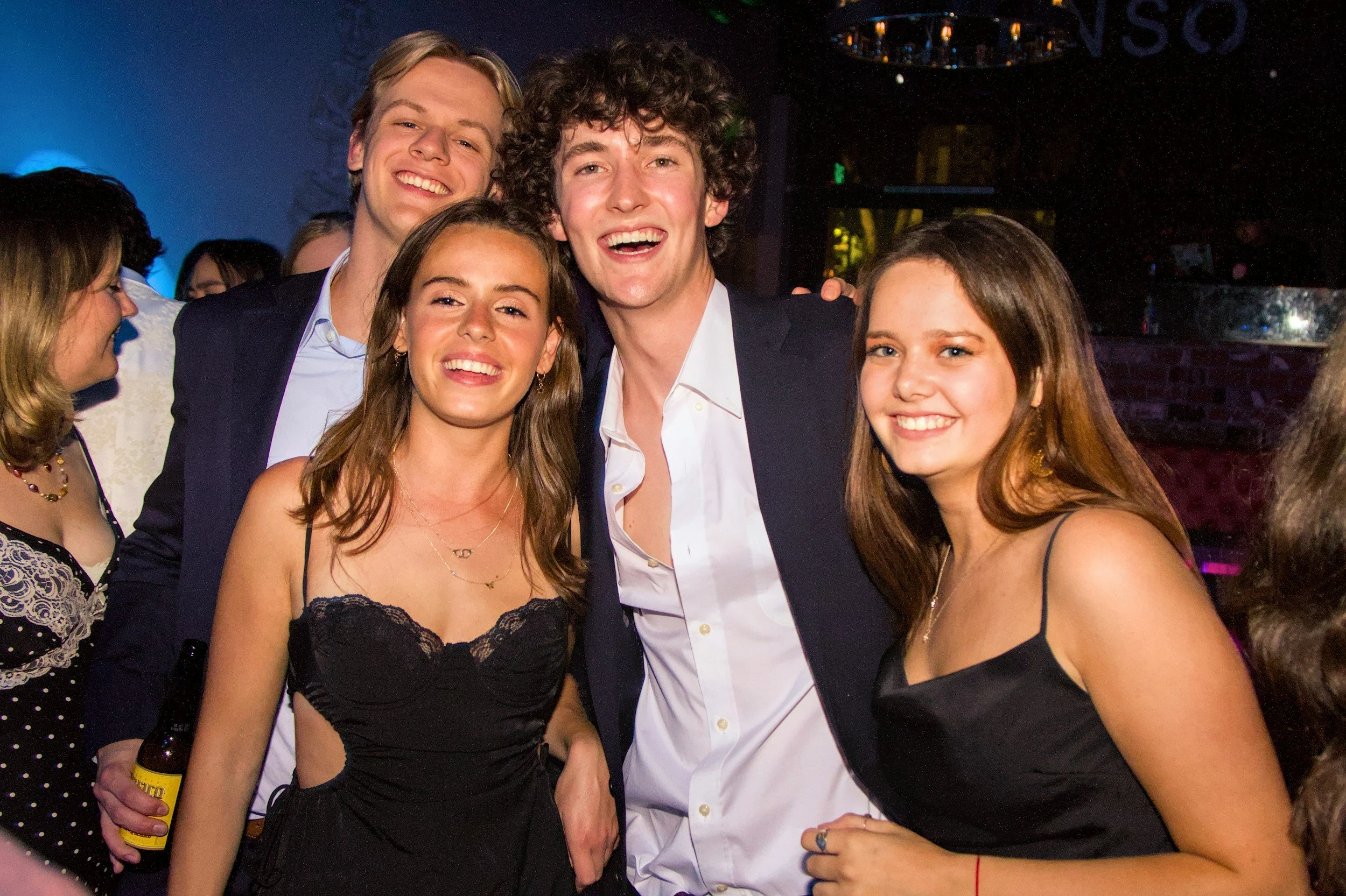 College-age fraternity and sorority members dressed for a formal event.