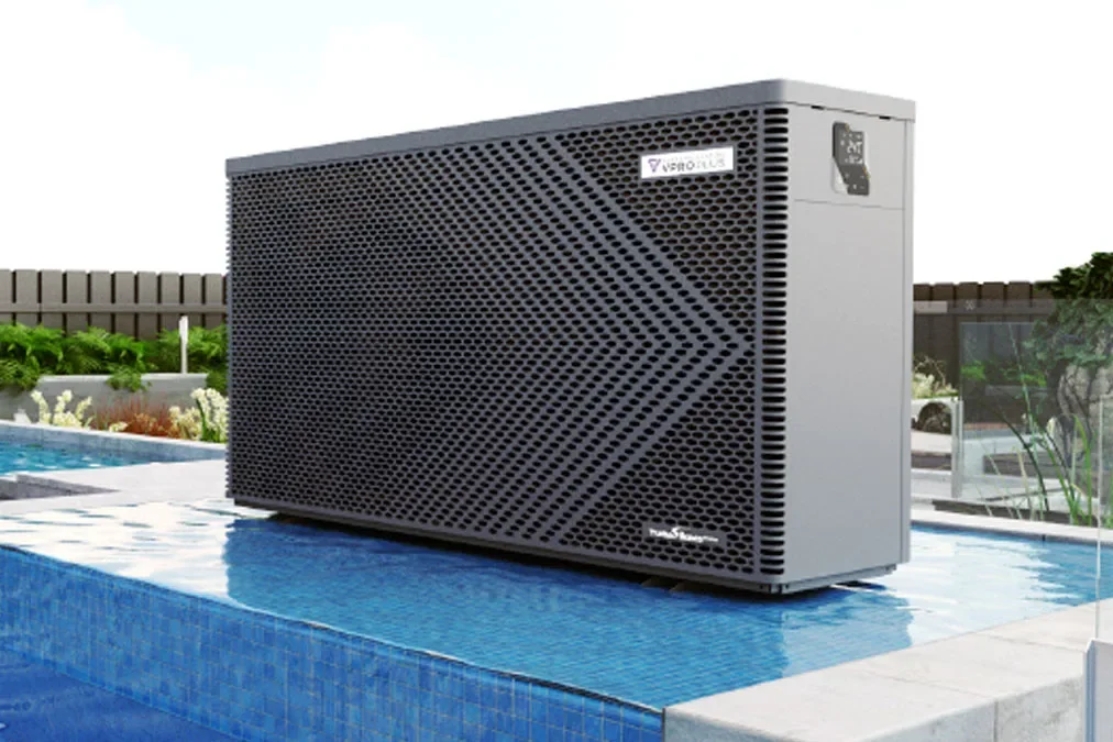 A poolside air conditioning or cooling unit with a digital display, situated on a tiled edge of a swimming pool in a backyard setting.
