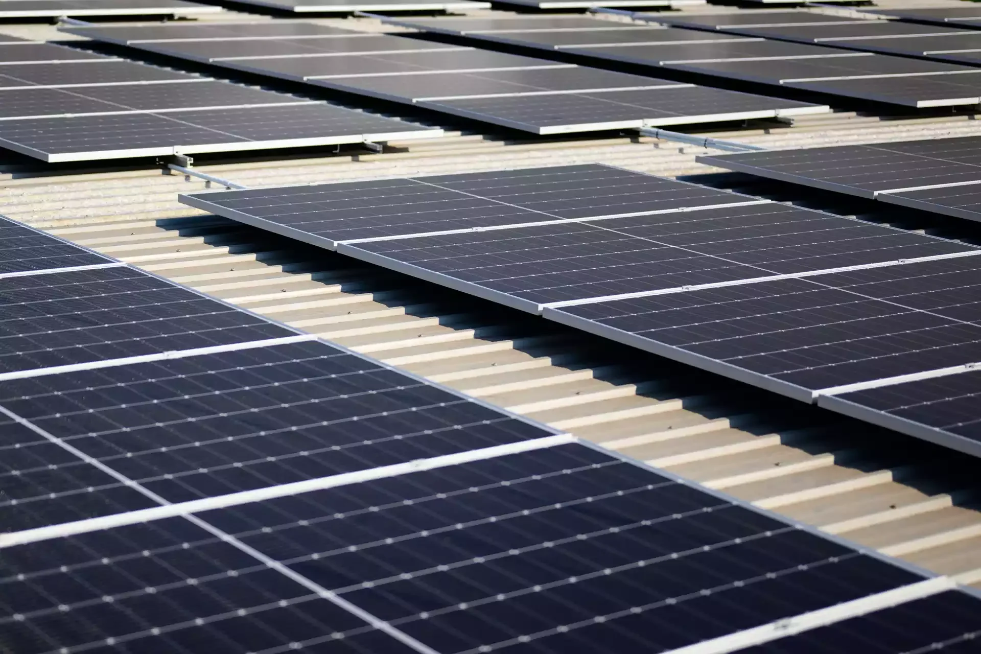 Multiple solar panels installed on a flat rooftop.