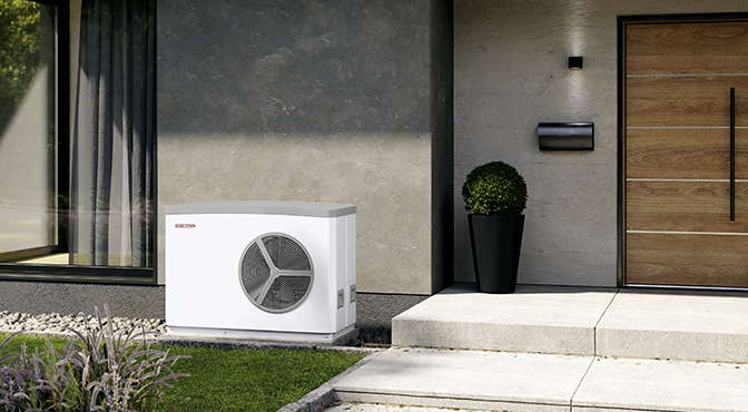 Outdoor heat pump or air conditioning unit near a modern house entrance with potted plant and a wooden door.
