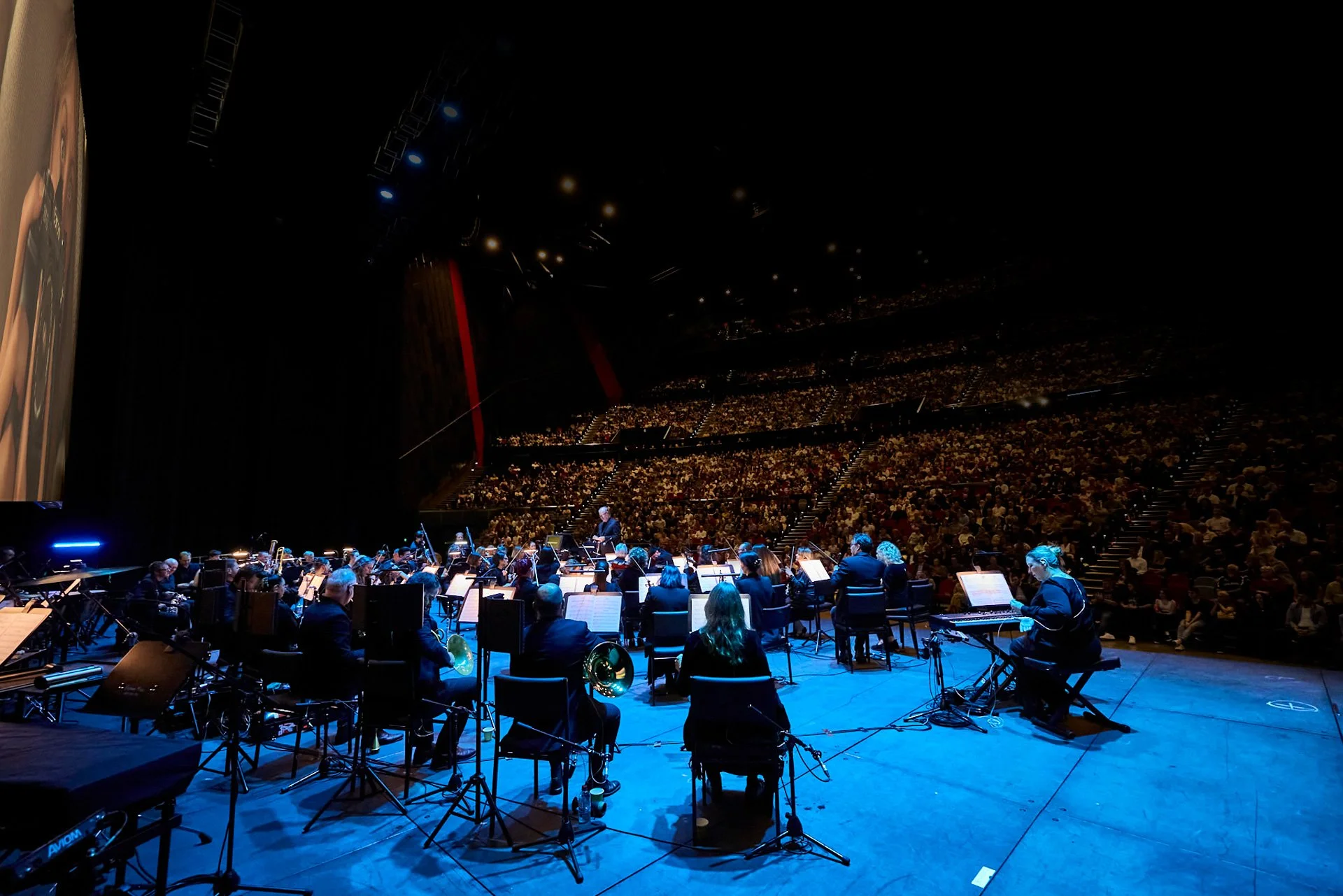 Photo of ICC Sydney with Orchestra playing in front of Crocodile Dundee on the big screen