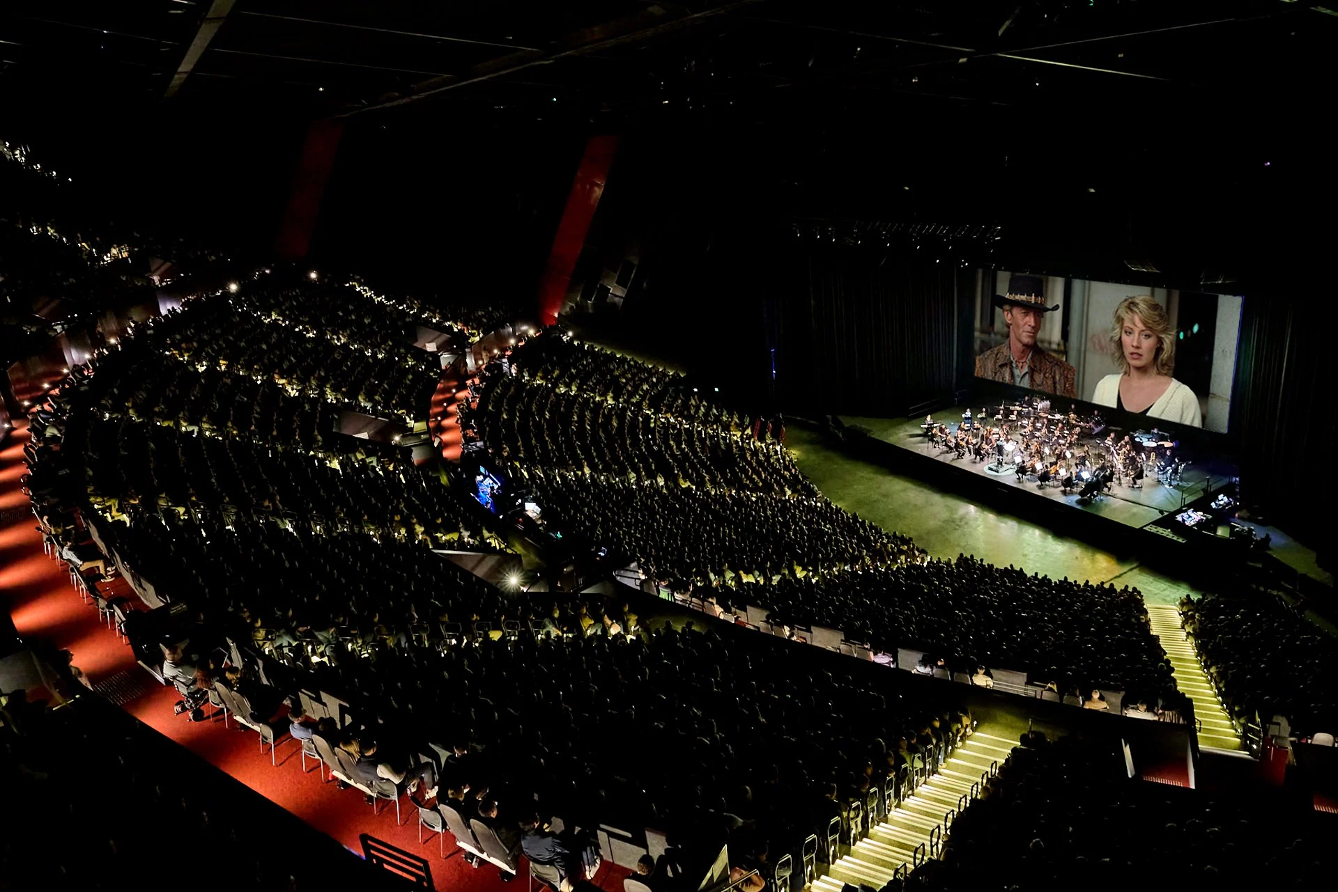 Photo of ICC Sydney with Orchestra playing in front of Crocodile Dundee on the big screen