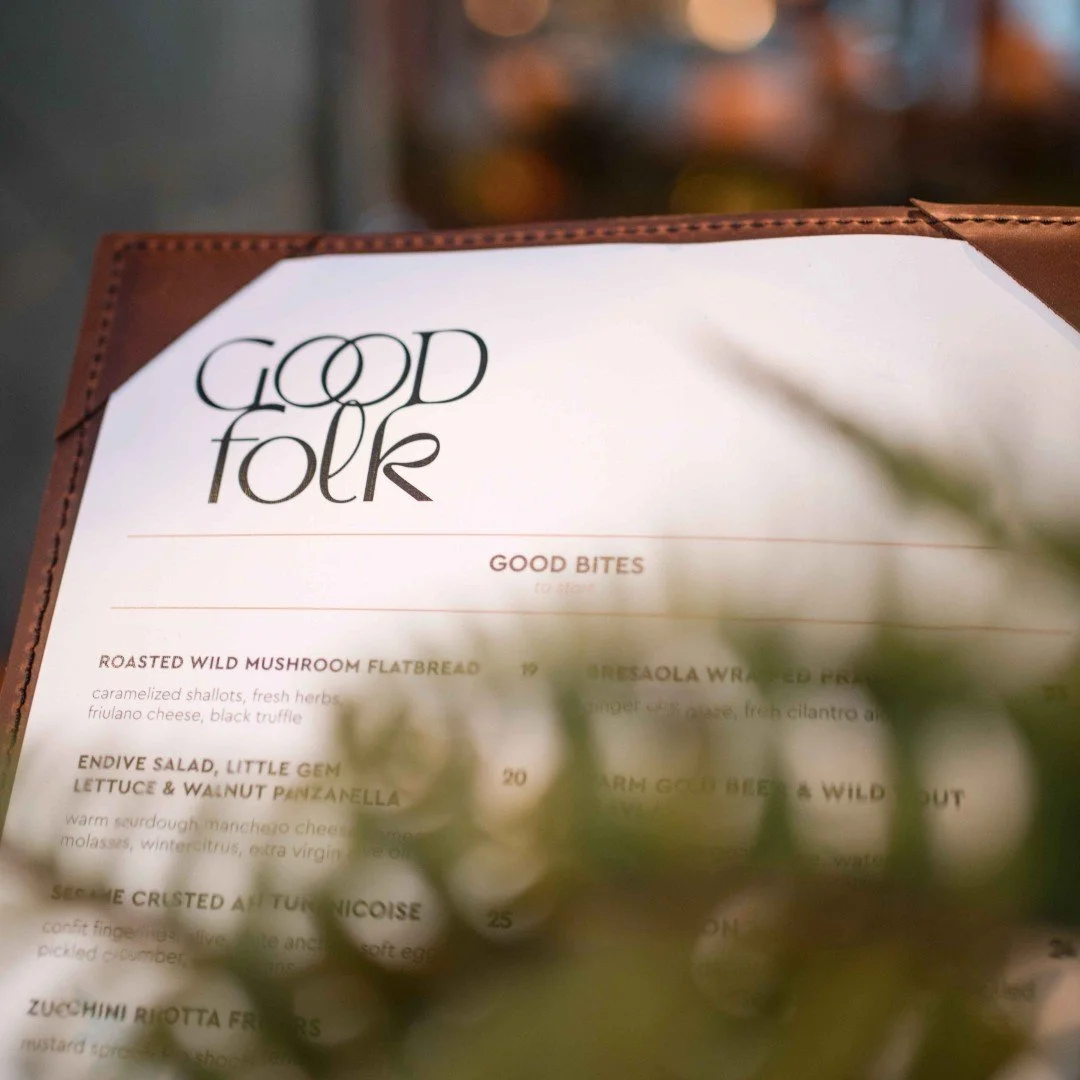 Close-up of a Good Folk restaurant menu featuring good bites, including roasted wild mushroom flatbread and endive salad.