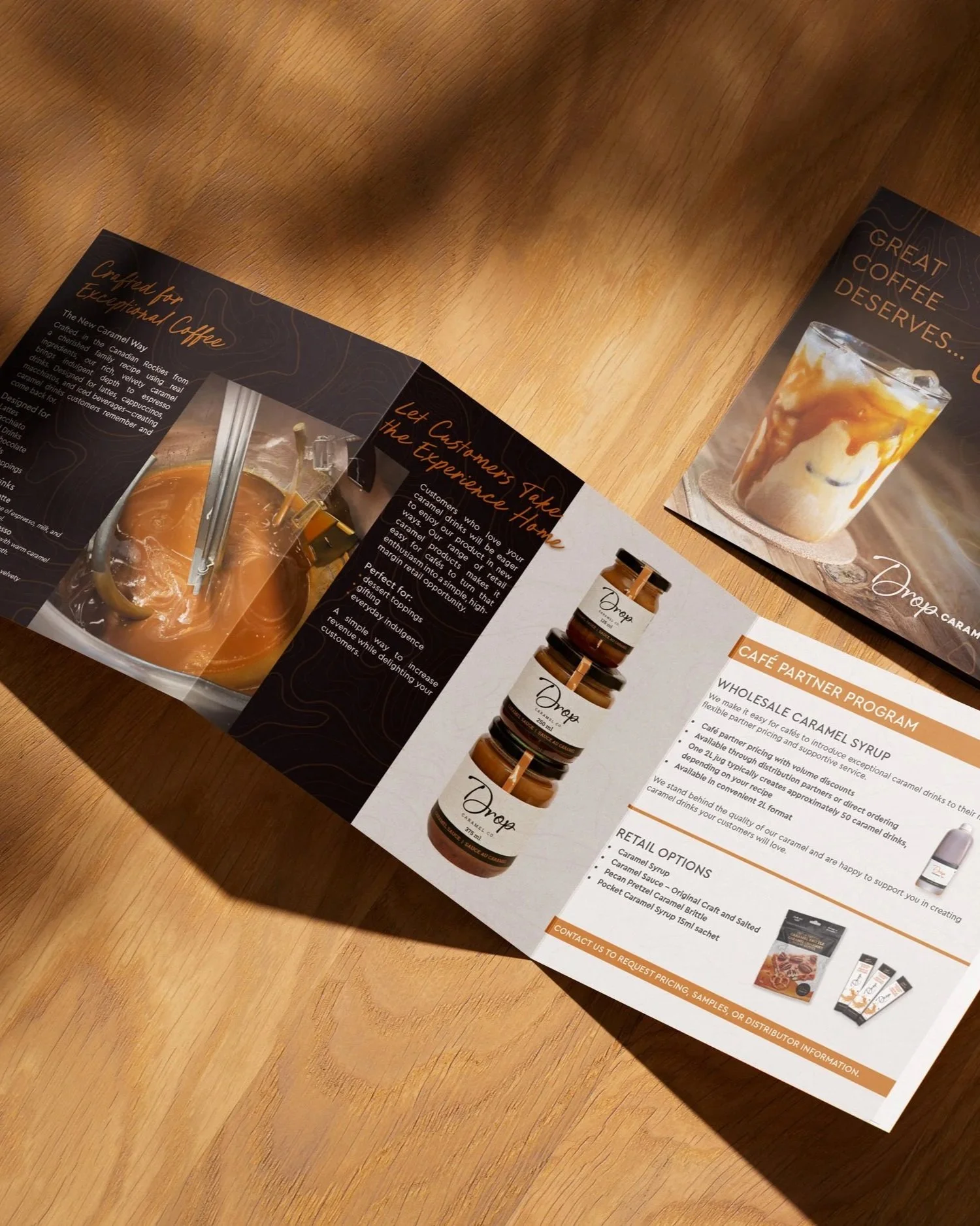 Open brochures on a wooden table showcasing caramel coffee drinks and caramel syrup products.