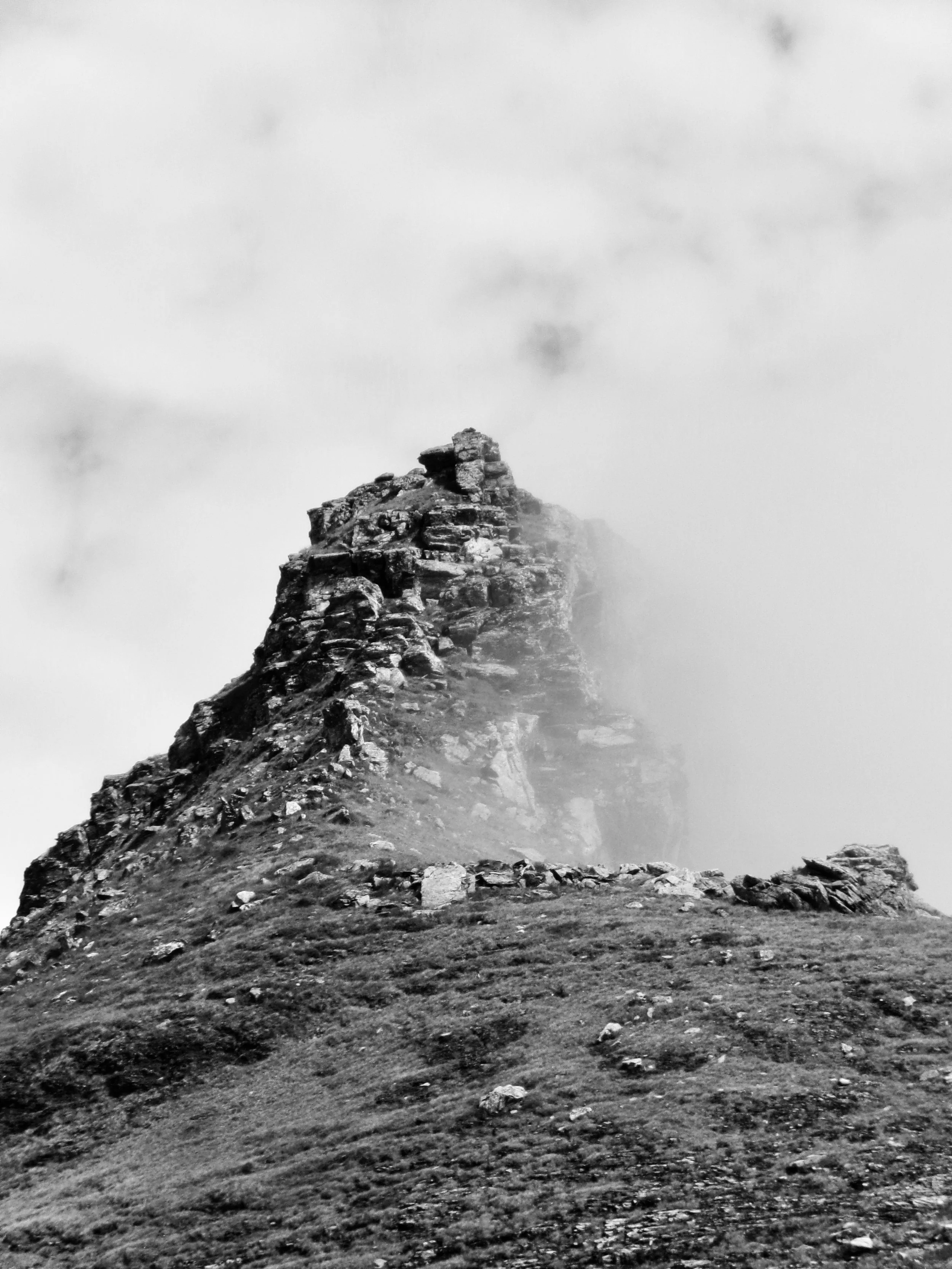 Mountain landscape disappearing into soft mist photographed by Larissa Maddy
