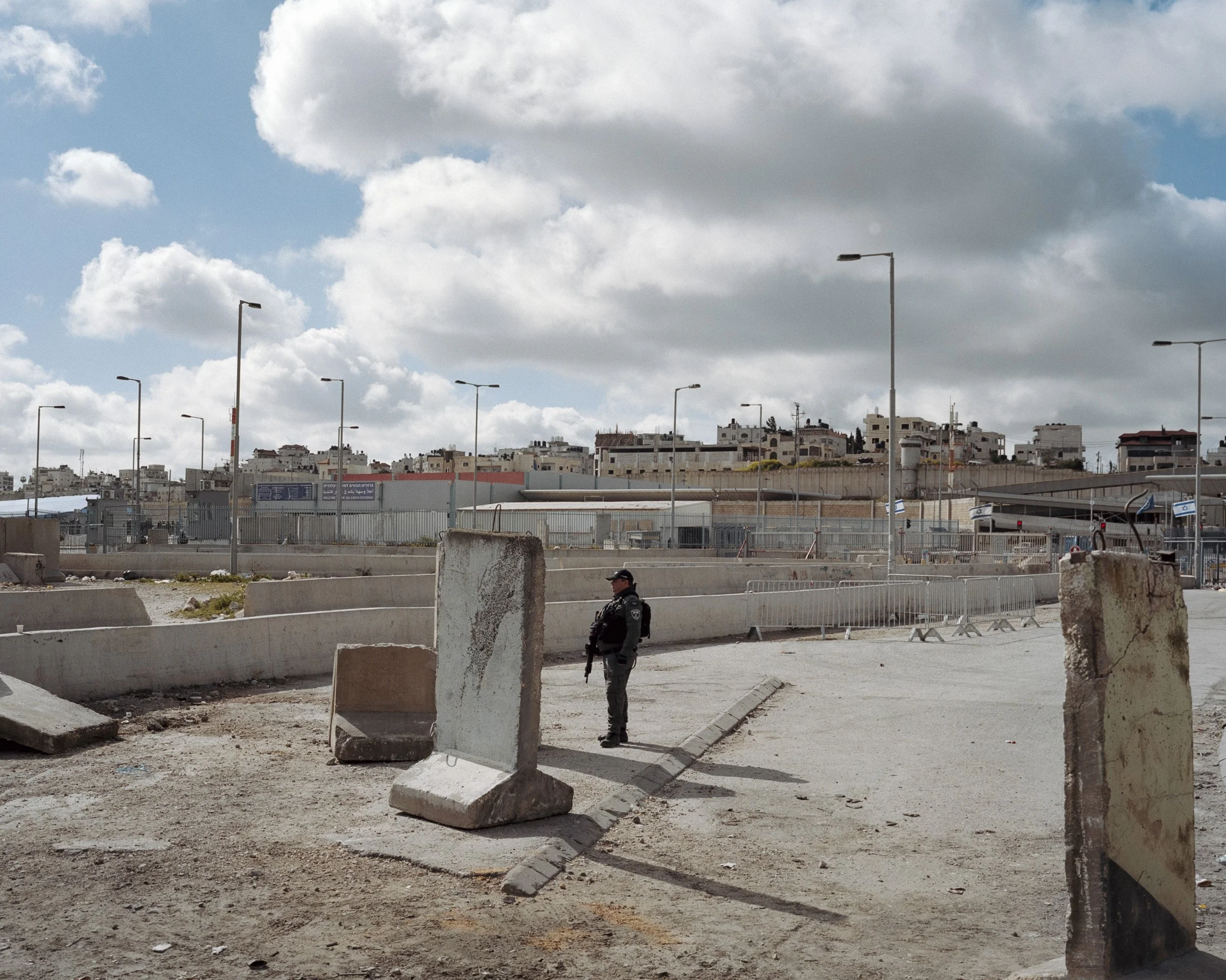 An Israeli border police officer guards the Qalandiya checkpoint, which is closed to traffic for the first Friday of Ramadan. March 15, 2024.