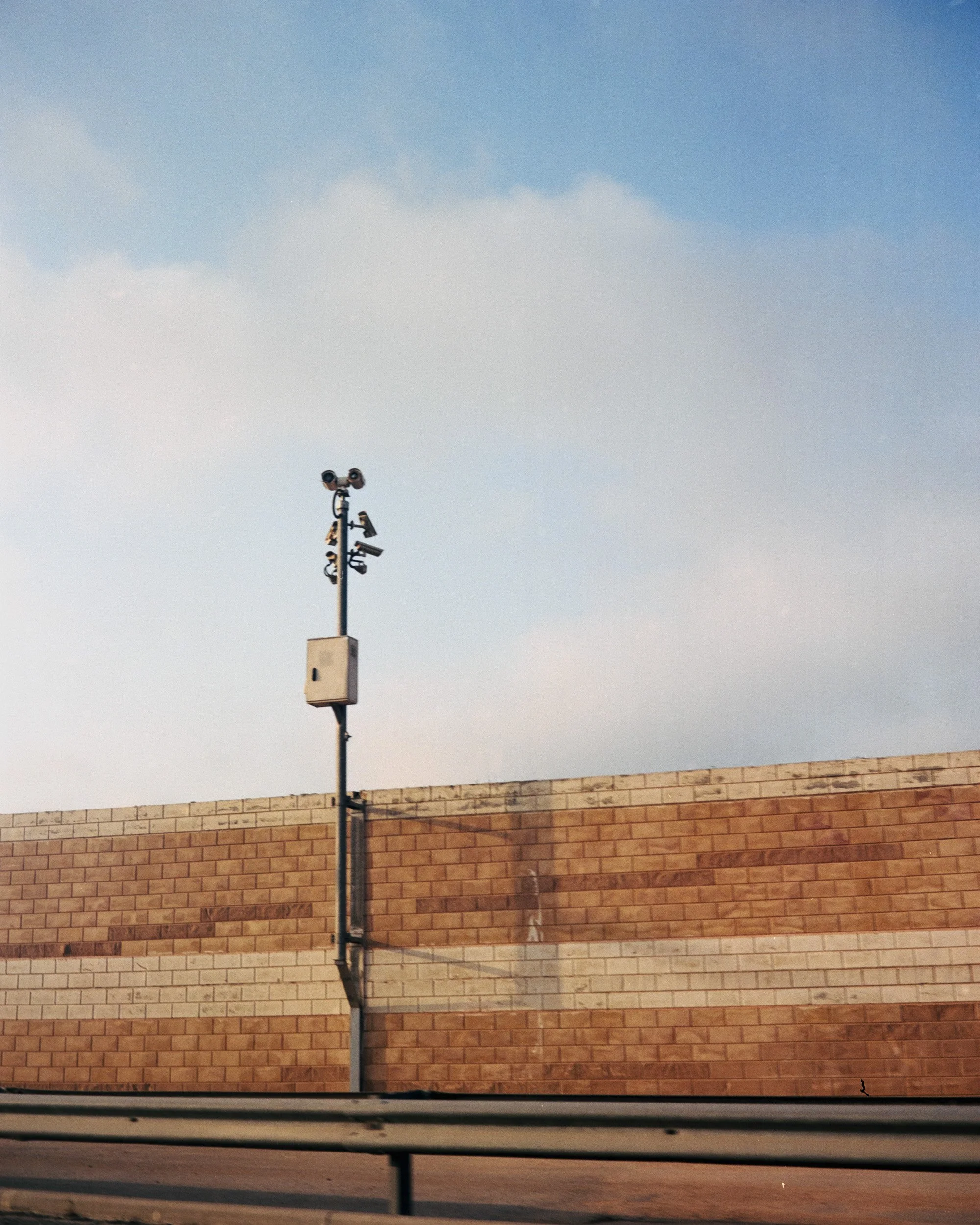 CCTV surveillance cameras pointing out of road 443, on the other side of the wall surrounding the freeway. . Only accessible to Israelis, the road is surrounded by walls and crosses part of the West Bank. September 5 2022.