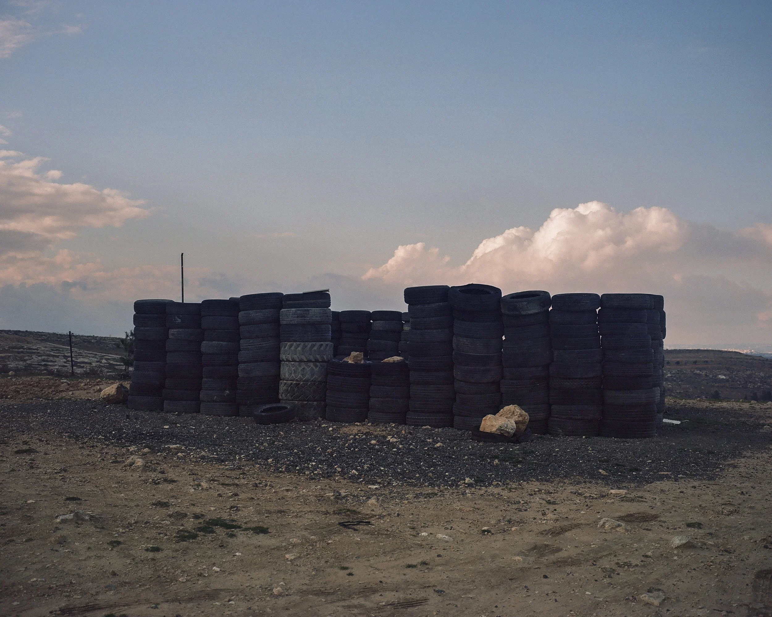 A tire structure used by the Bedouins of the village of Al-Mufaqarah (West Bank) as a meeting space, with a sheet added to form the roof.