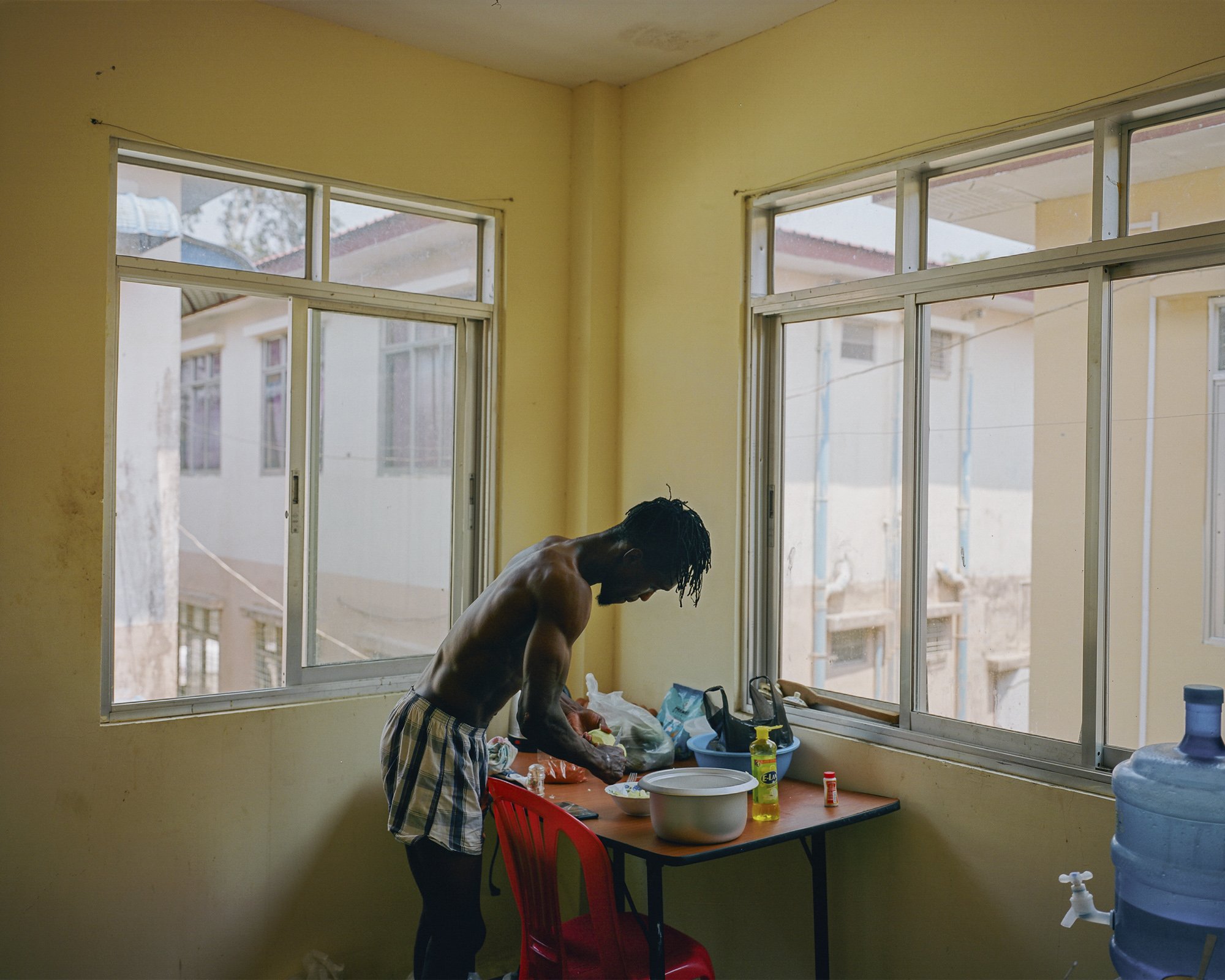 Kelvin prepares lunch, Rahine United FC dorms, near Watharli stadium, Sittwe, Rakhine State, Myanmar. April 24 2019. © Lucien Lung / Riva