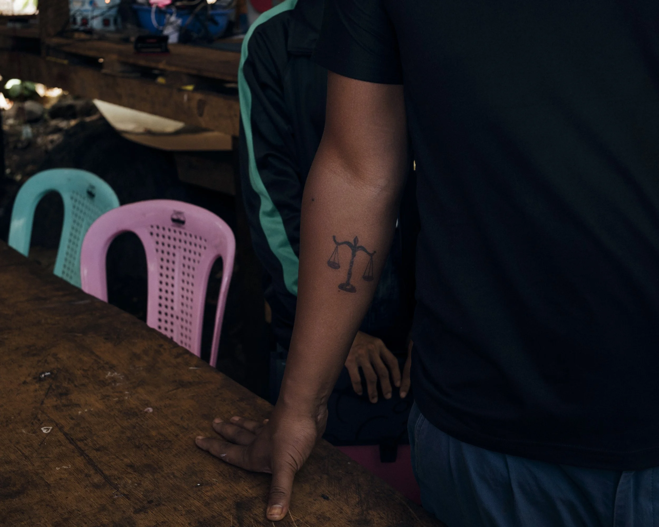 A scale tattooed on the right arm of Judge Saw Day, a former rebel soldier turned-judge. Karenni State Police Station 9, on the outskirts of Demoso, Karenni State, Myanmar.
