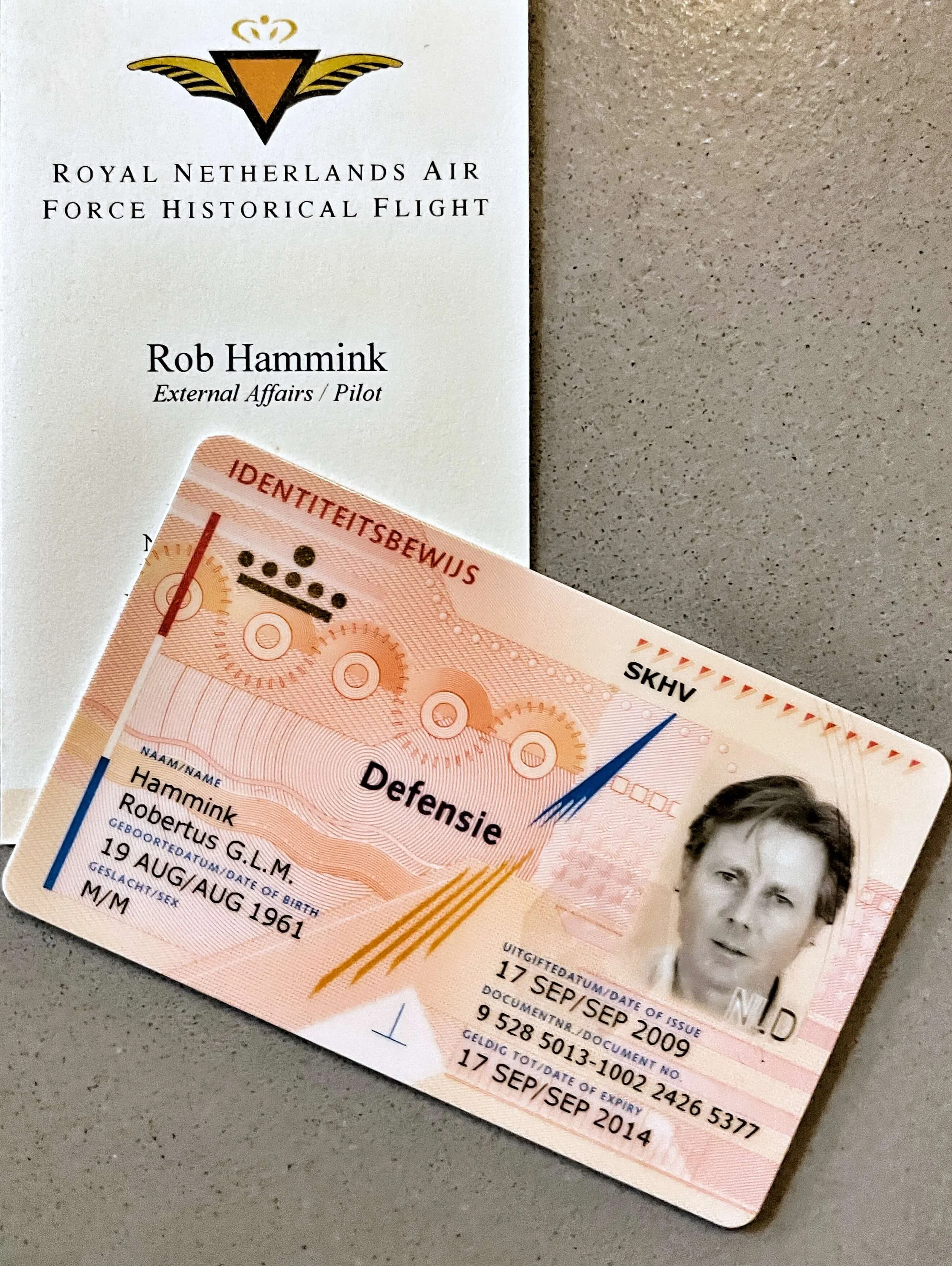 A person's identification card for the Royal Netherlands Air Force, showing personal details, a black and white photo, and various official markings and dates.