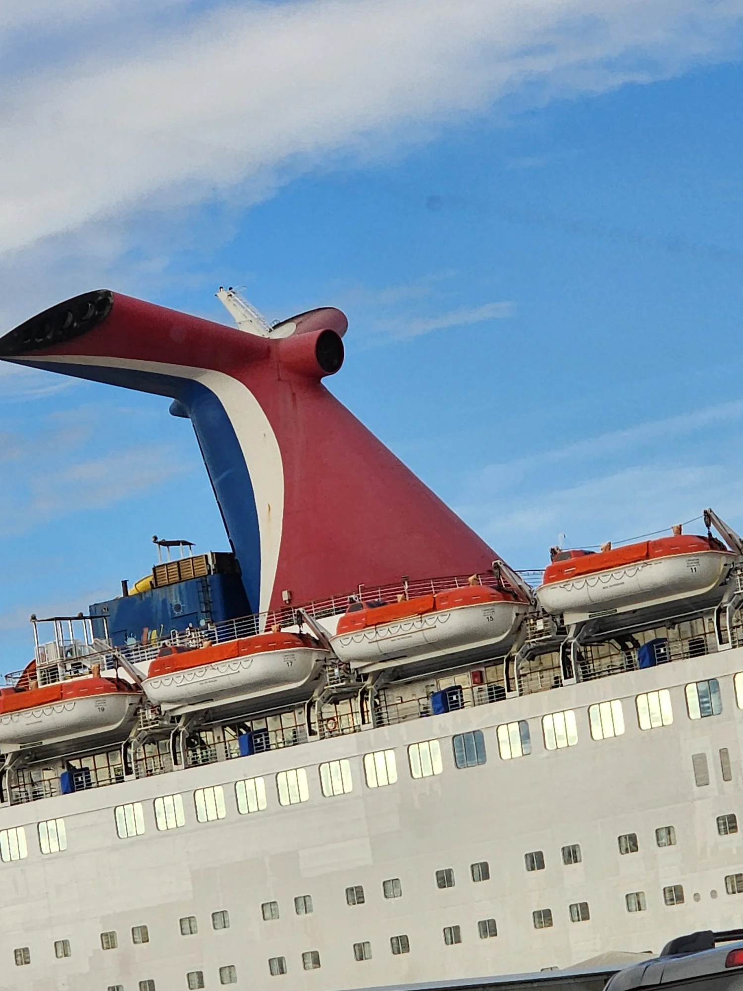 Cruise ship exterior with funnel and lifeboats