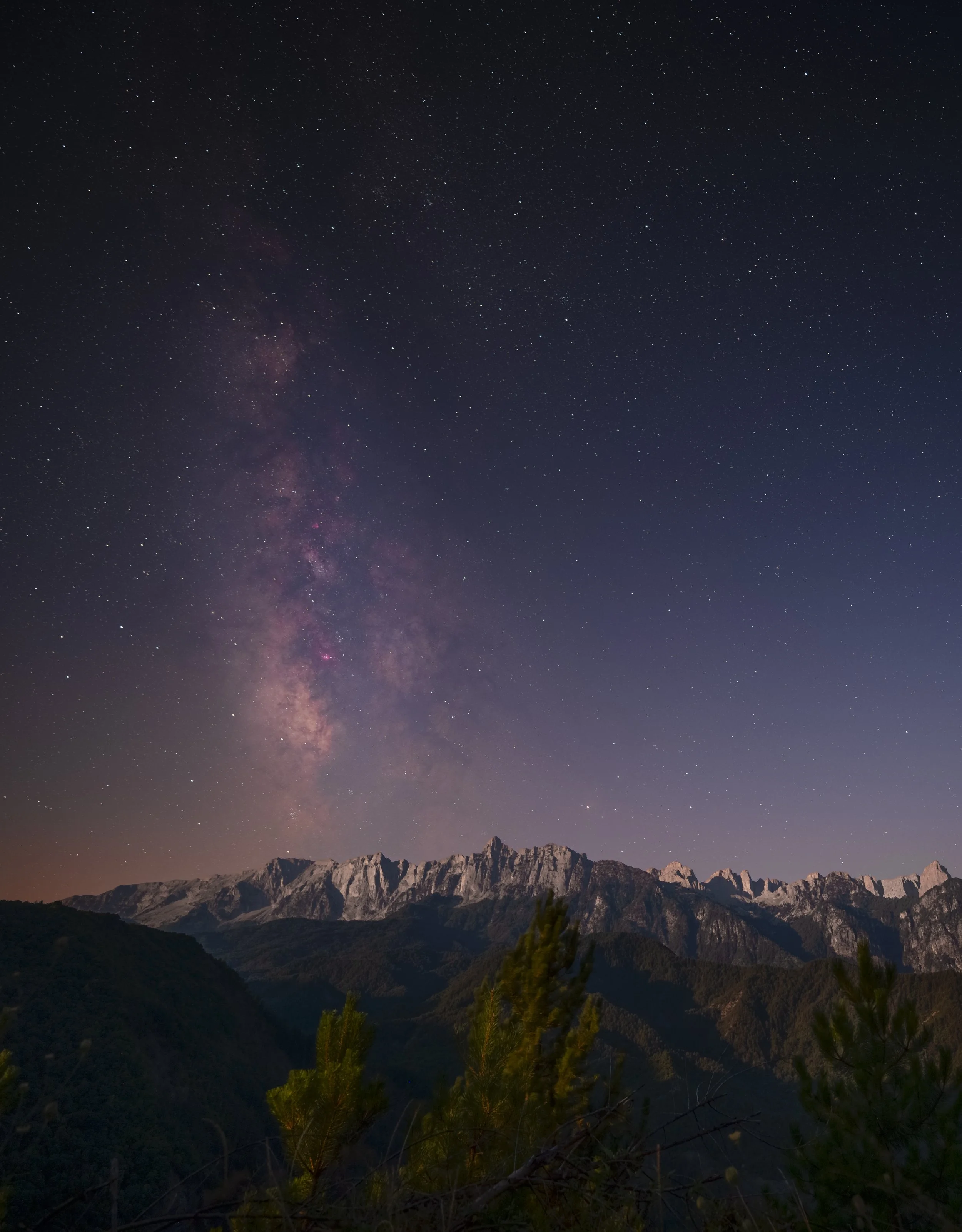The Milky Way over the limestone ridge of Mount Tymfi, Pindos, northern Greece — the range holds some of the darkest skies in the country, and the Vikos Gorge cutting through it below is among the deepest in the world relative to its width.