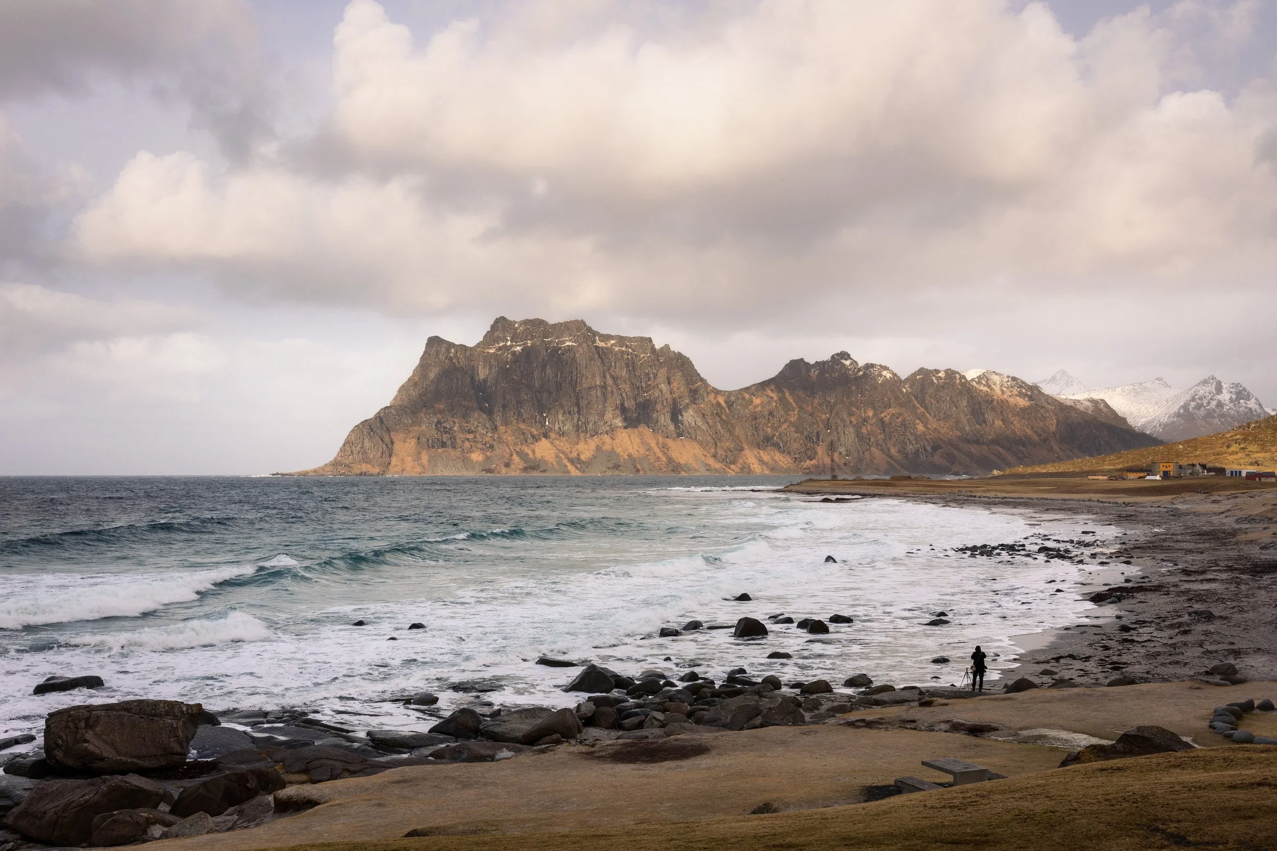 A photographer on the shore at Uttakleiv, Lofoten, Norway