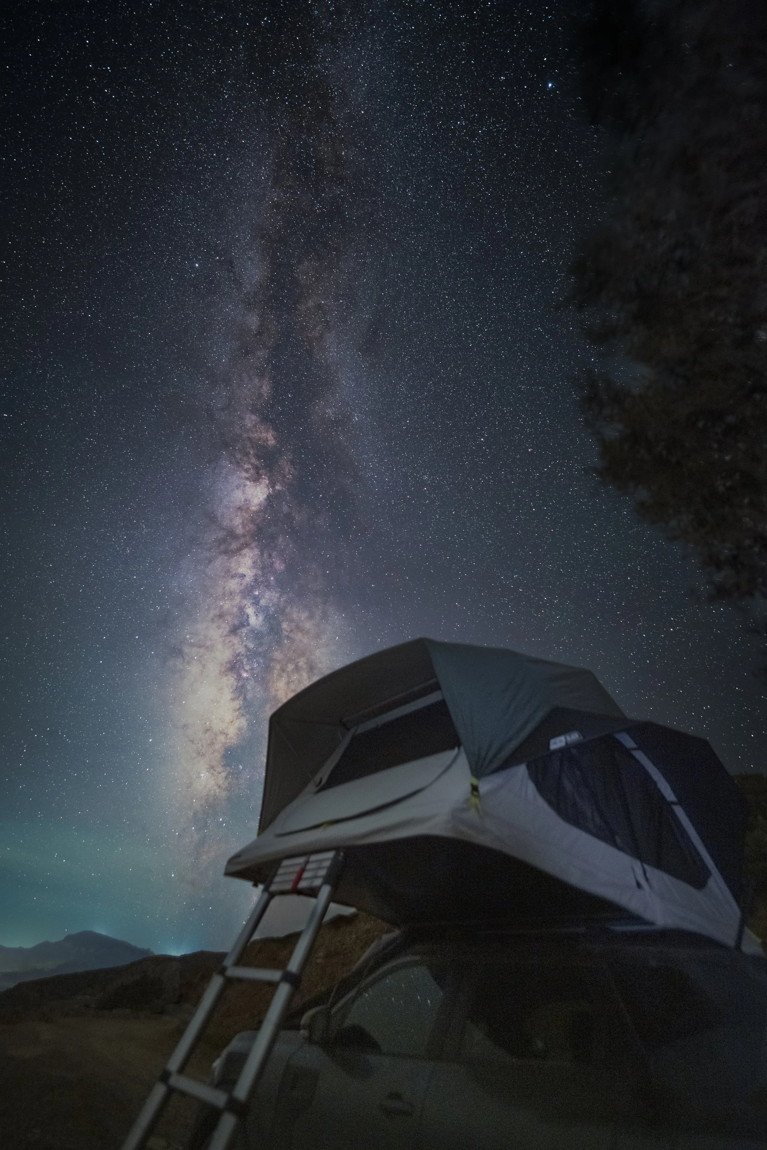 The Milky Way core above a Quechua rooftop tent, in Karpathos, Greece — one of the least populated islands in the Aegean, with almost nothing between the campsite and the horizon to lift the sky.