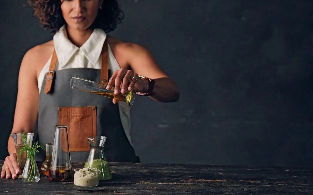 mixologist-pouring-liquid-into-beaker.jpg