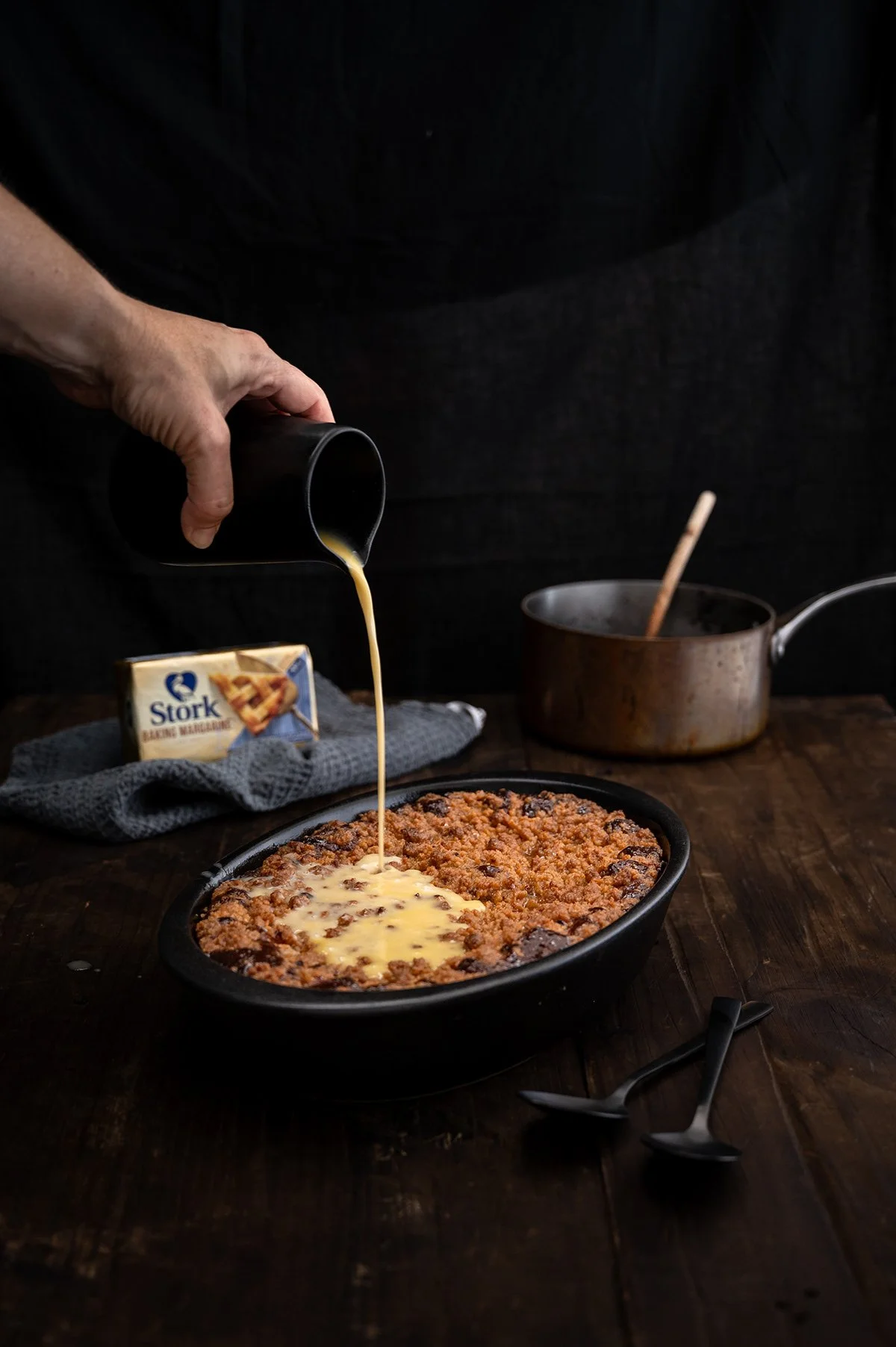 stork-malva-pudding-custard-pour-hand.jpg