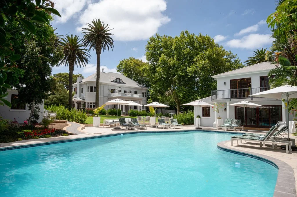 manor-guesthouse-pool-patio-loungers.jpg