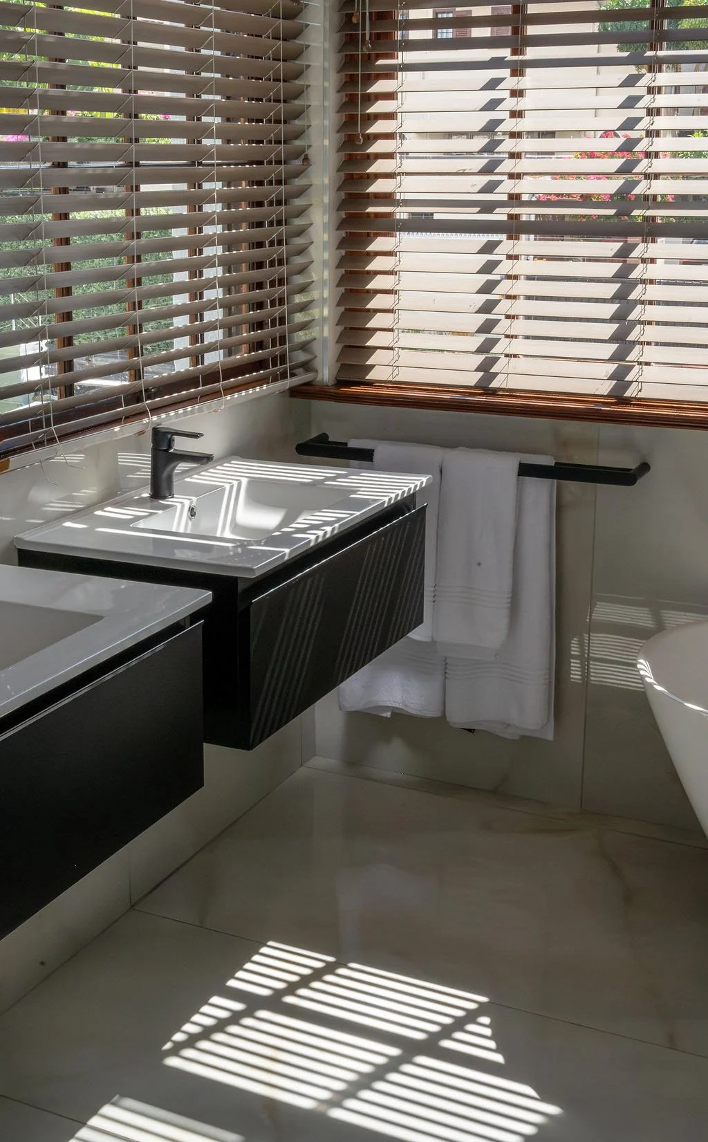modern-bathroom-black-vanity-wooden-blinds.jpg