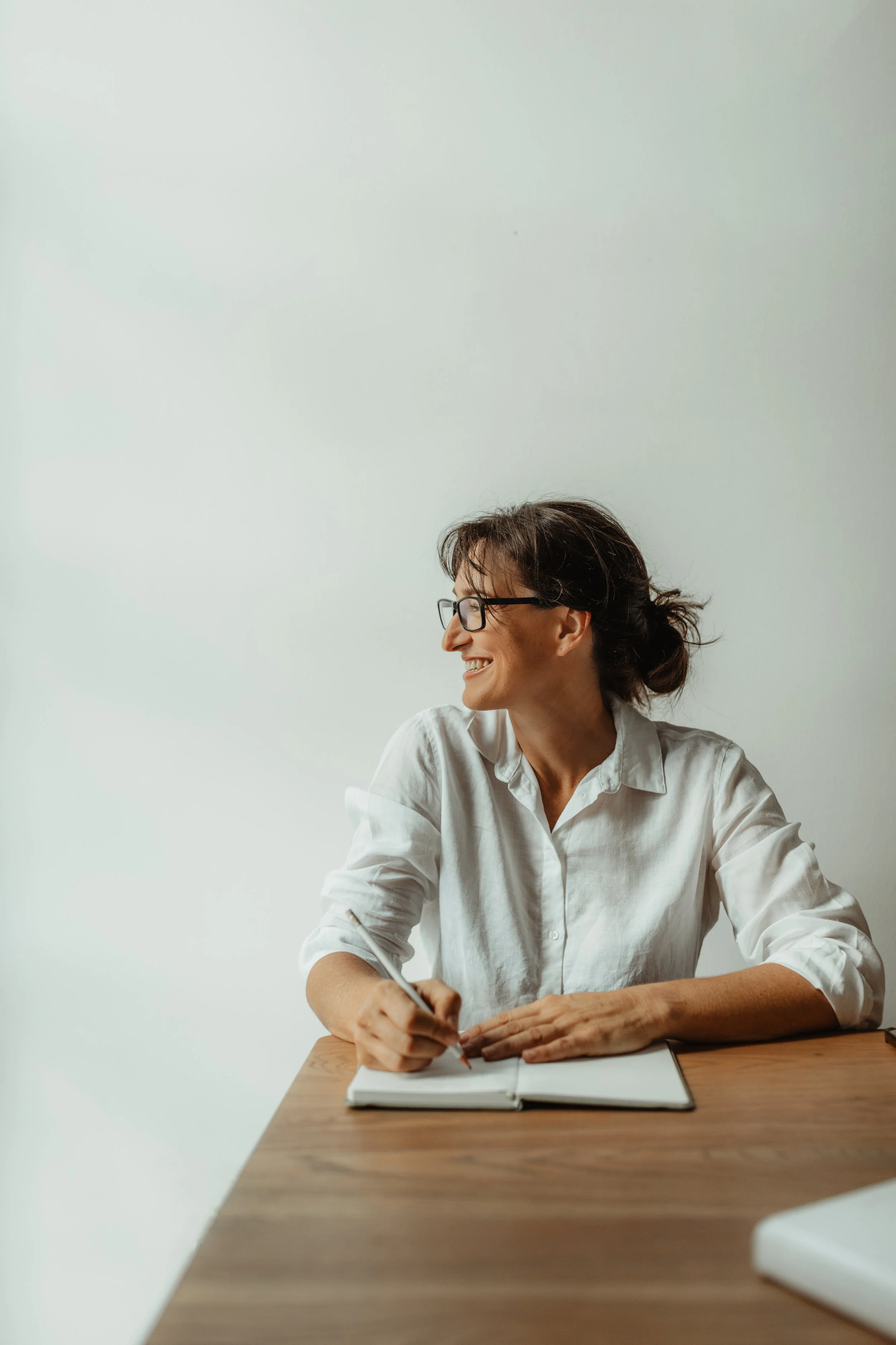 Creative small business owner writing notes during a mentorship session in Cape Town