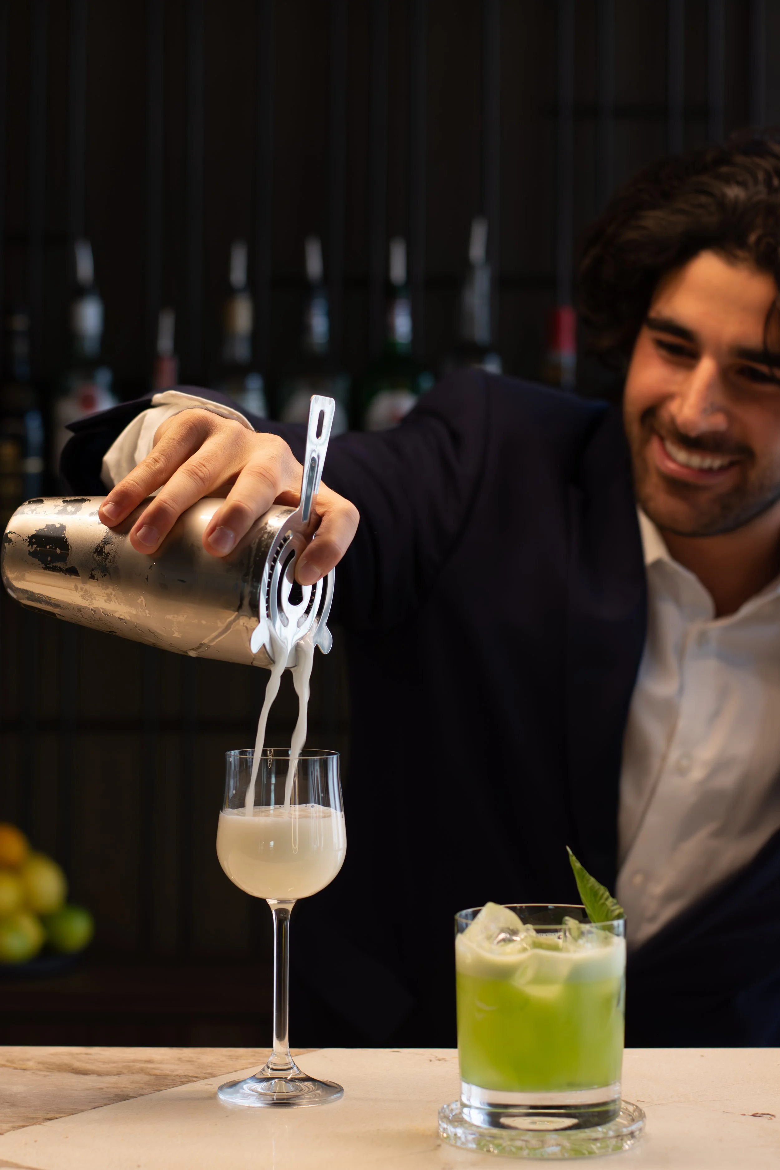 mertia-bartender-pouring-pisco-sour-cocktail.jpg