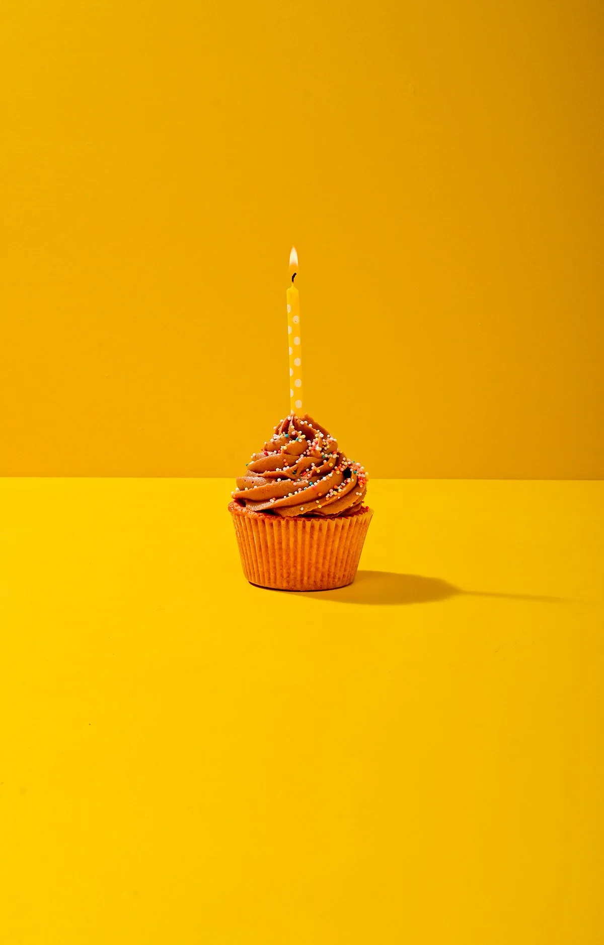 chocolate-cupcake-lit-candle-yellow.jpg