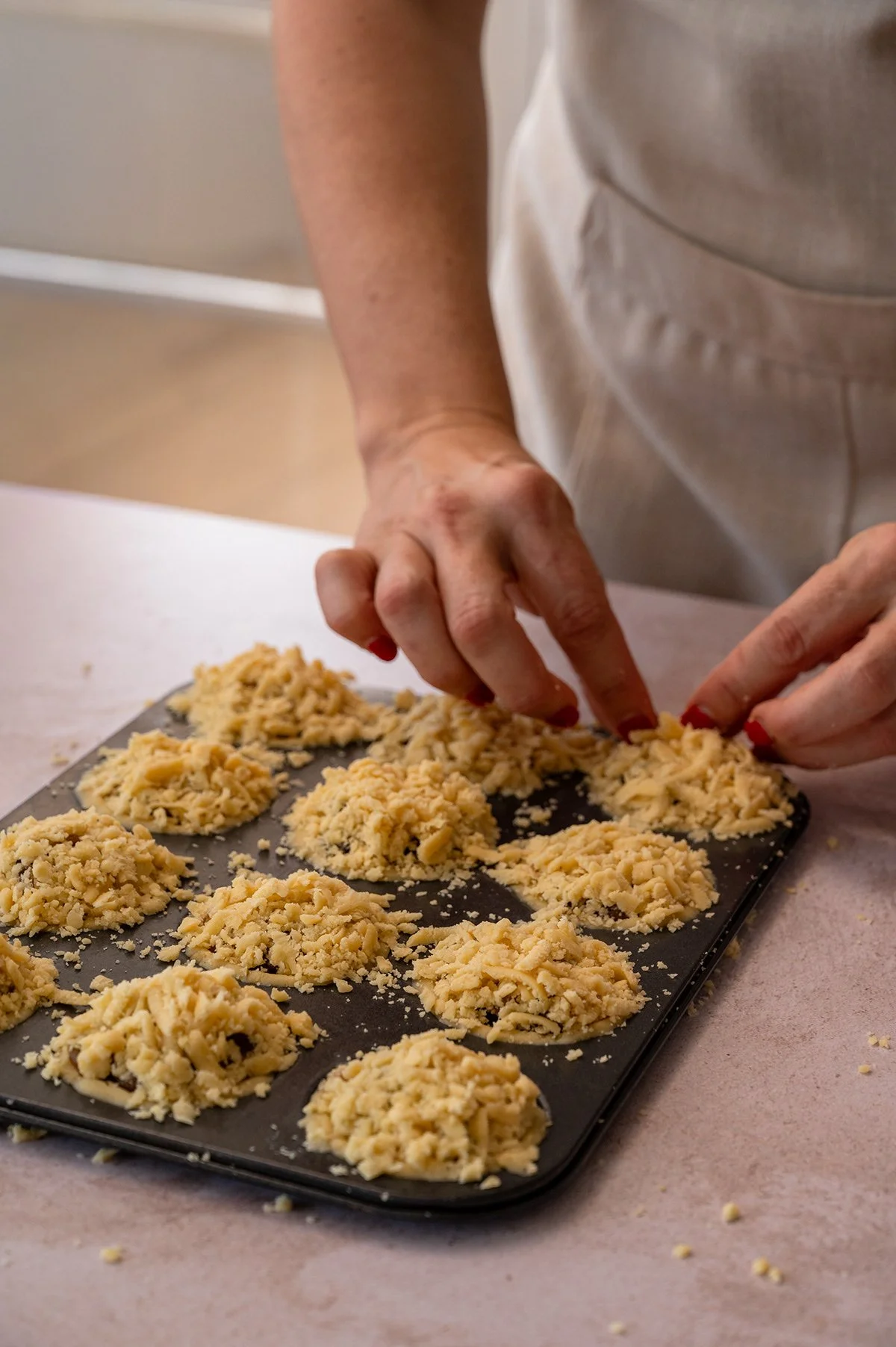 crumble-topping-muffin-tray-hands.jpg