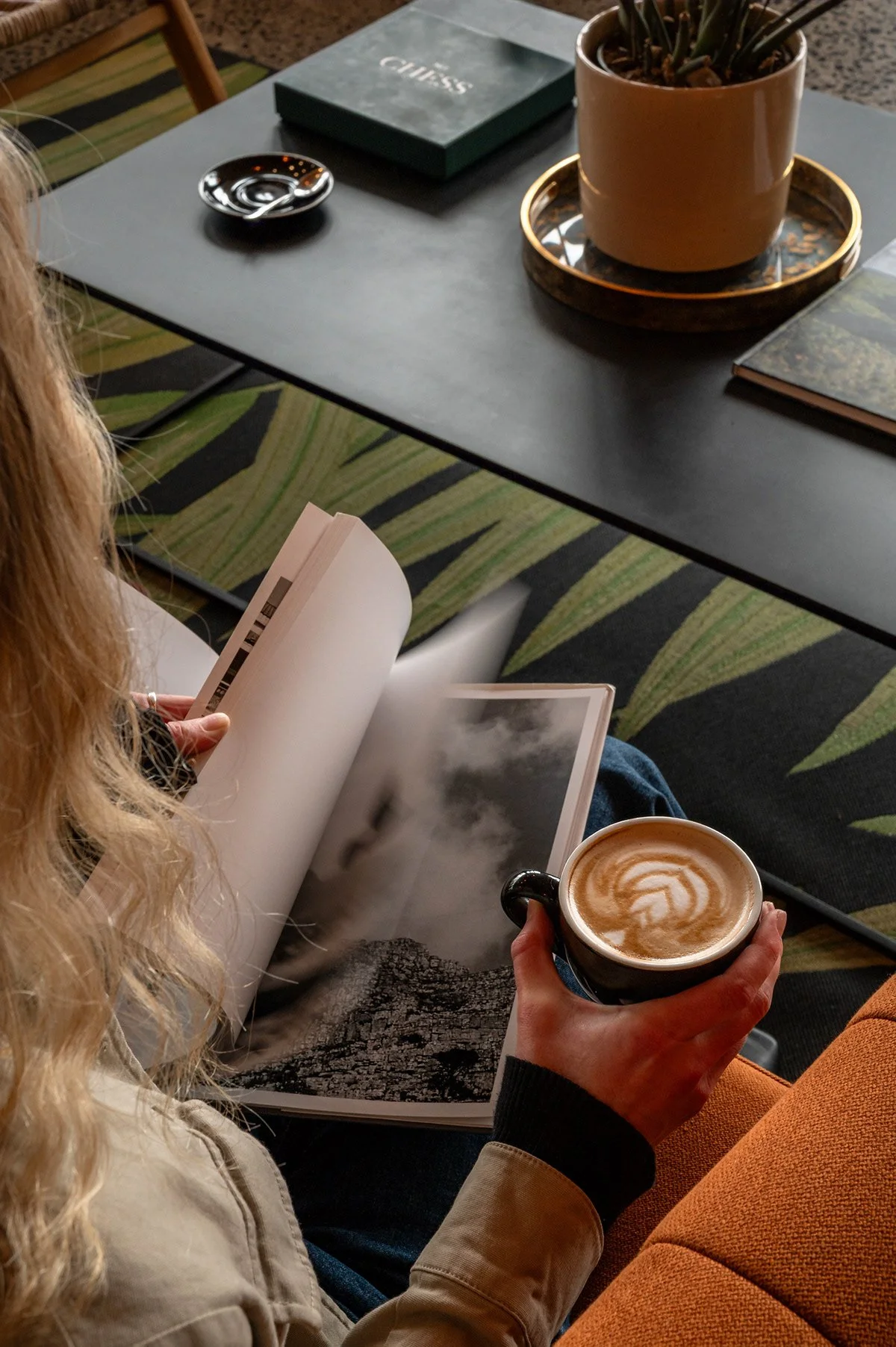 guest-reading-coffee-lounge-palm-rug.jpg