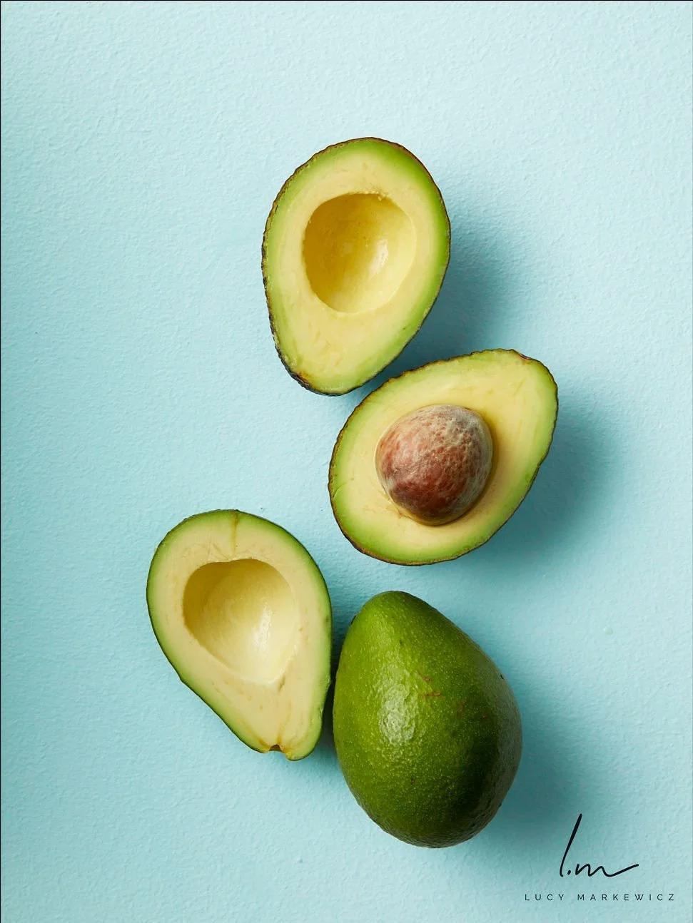 fresh-avocados-halved-on-turquoise.jpeg