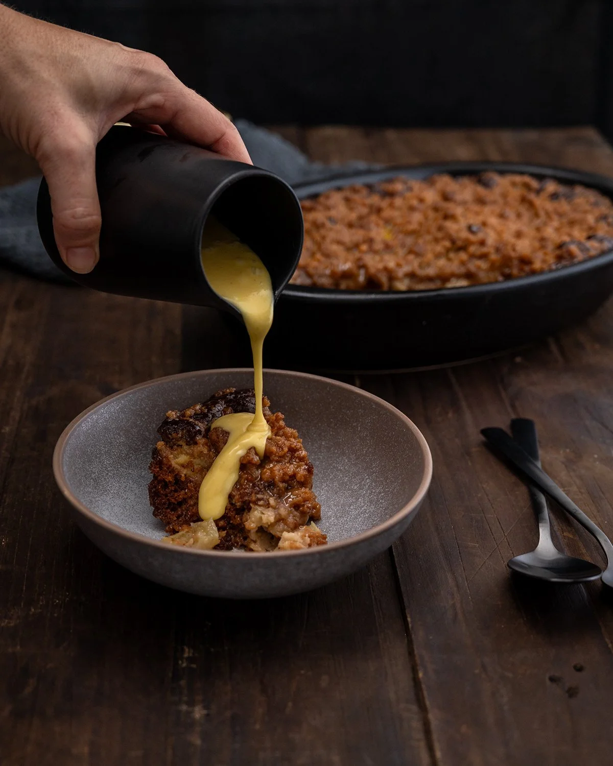 stork-apple-crumble-custard-pour-black-dish.jpg