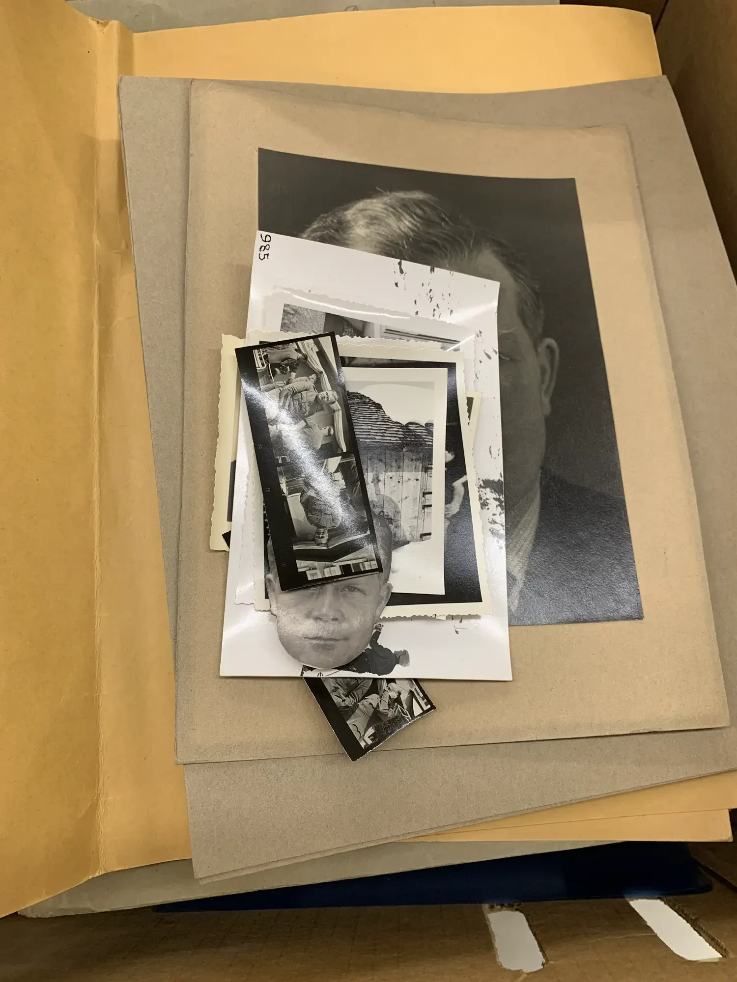 Loose historical photographs without protective sleeves prior to conservation treatment.