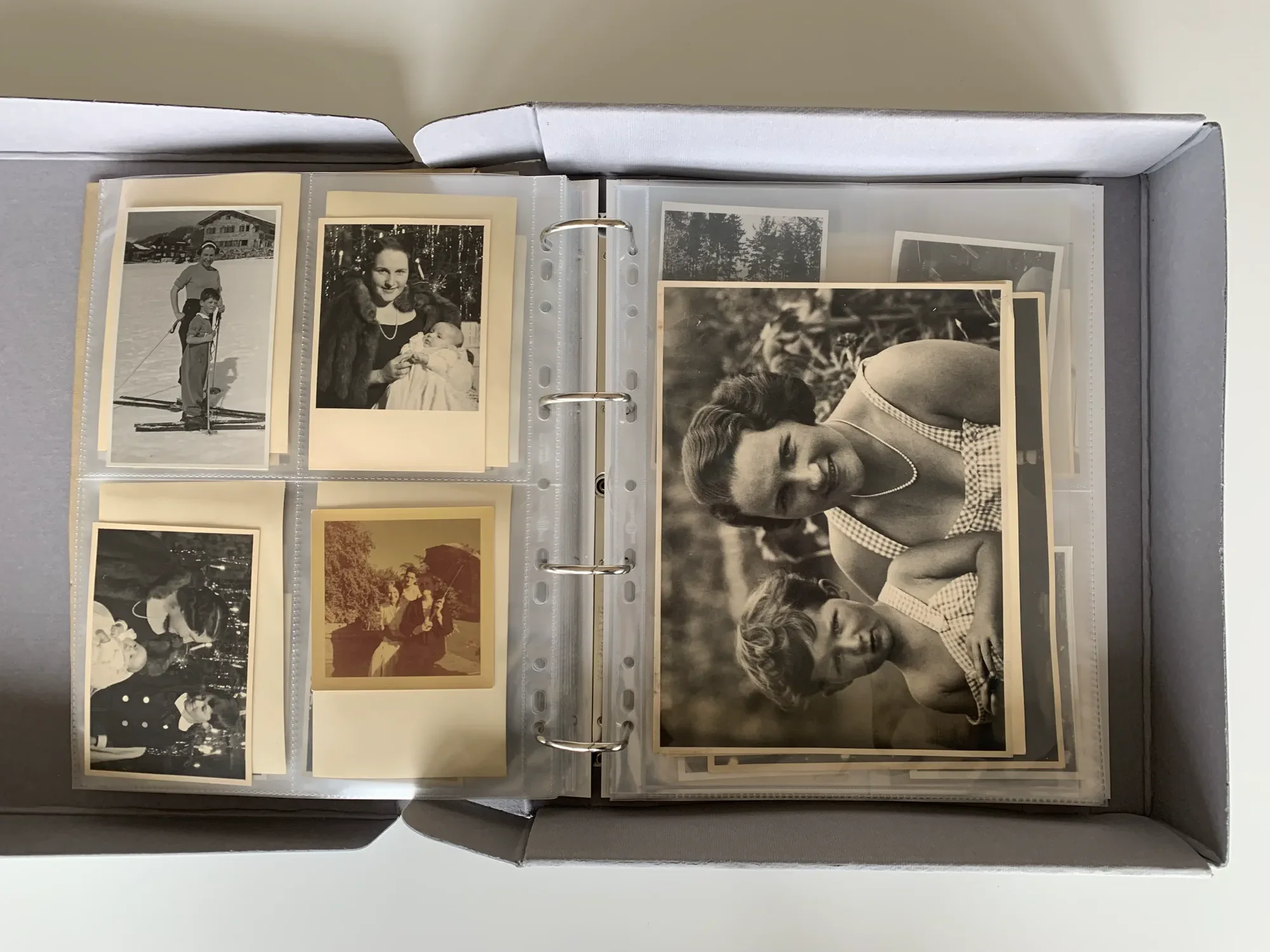 Historical photographs are protected in archival-quality sleeves and stored in an organized manner.