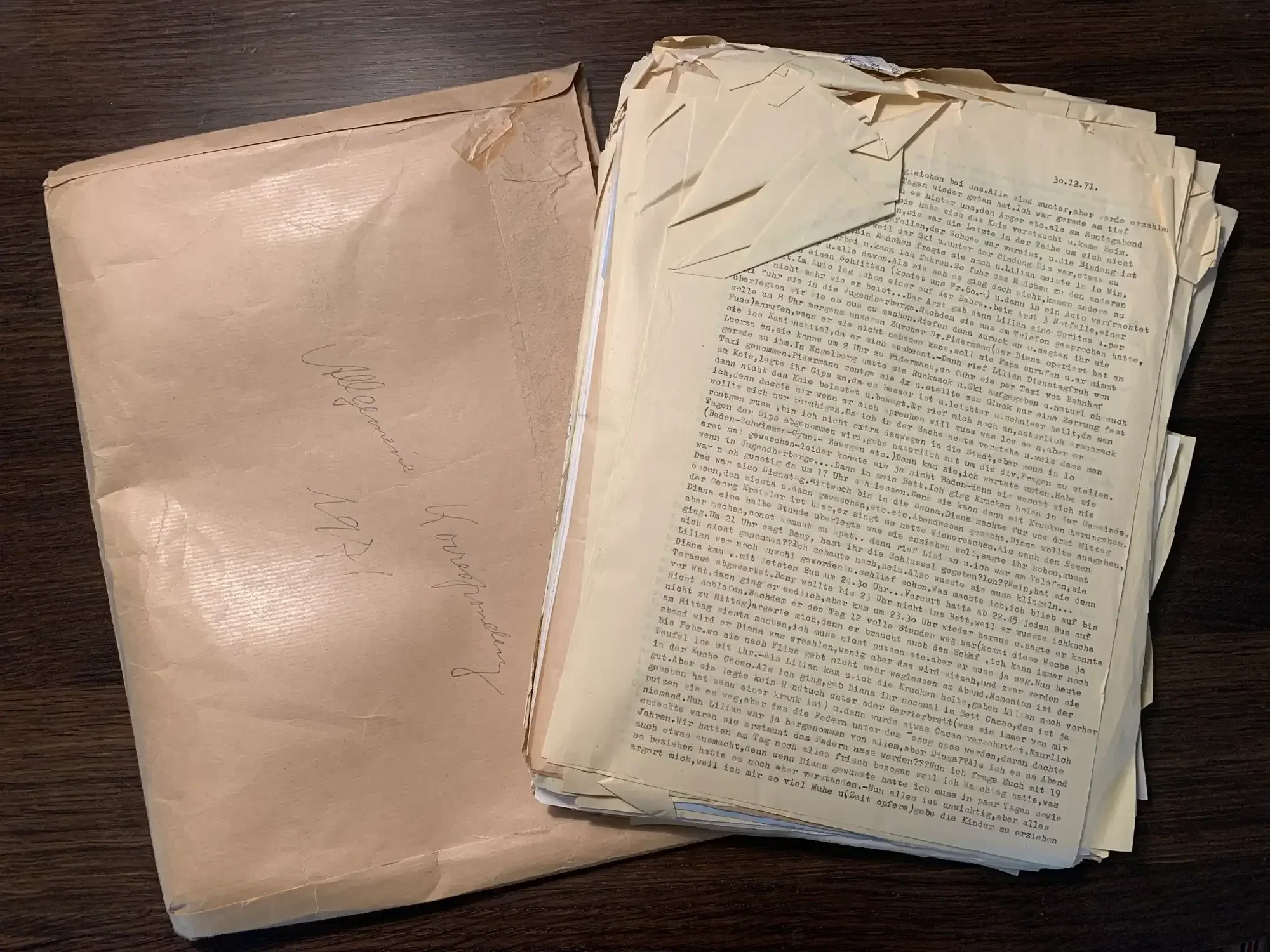 Archival documents with creased corners before being gently smoothed out.