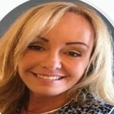 Close-up of a smiling woman with blonde hair and light makeup
