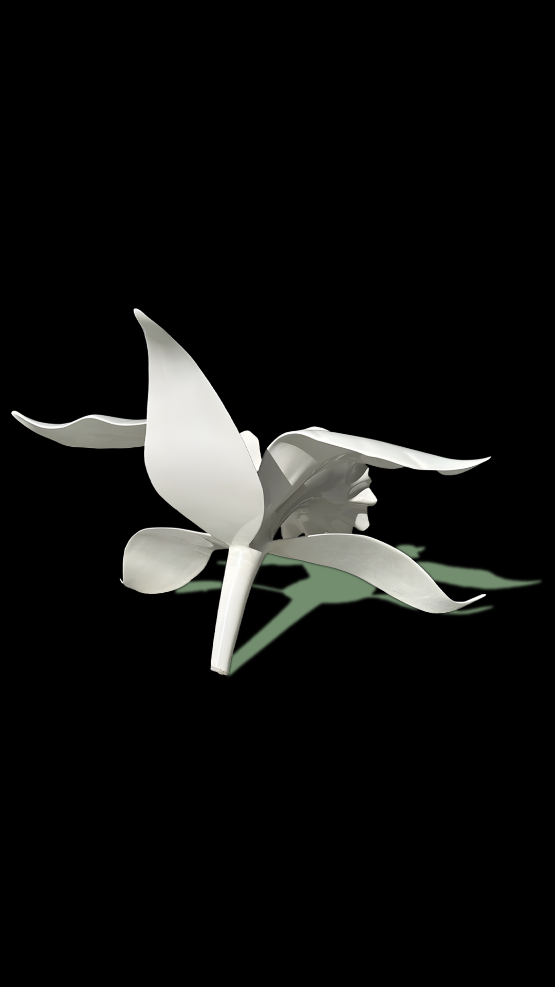 A white artificial flower with smooth, curved petals against a black background, casting a shadow on a green surface.